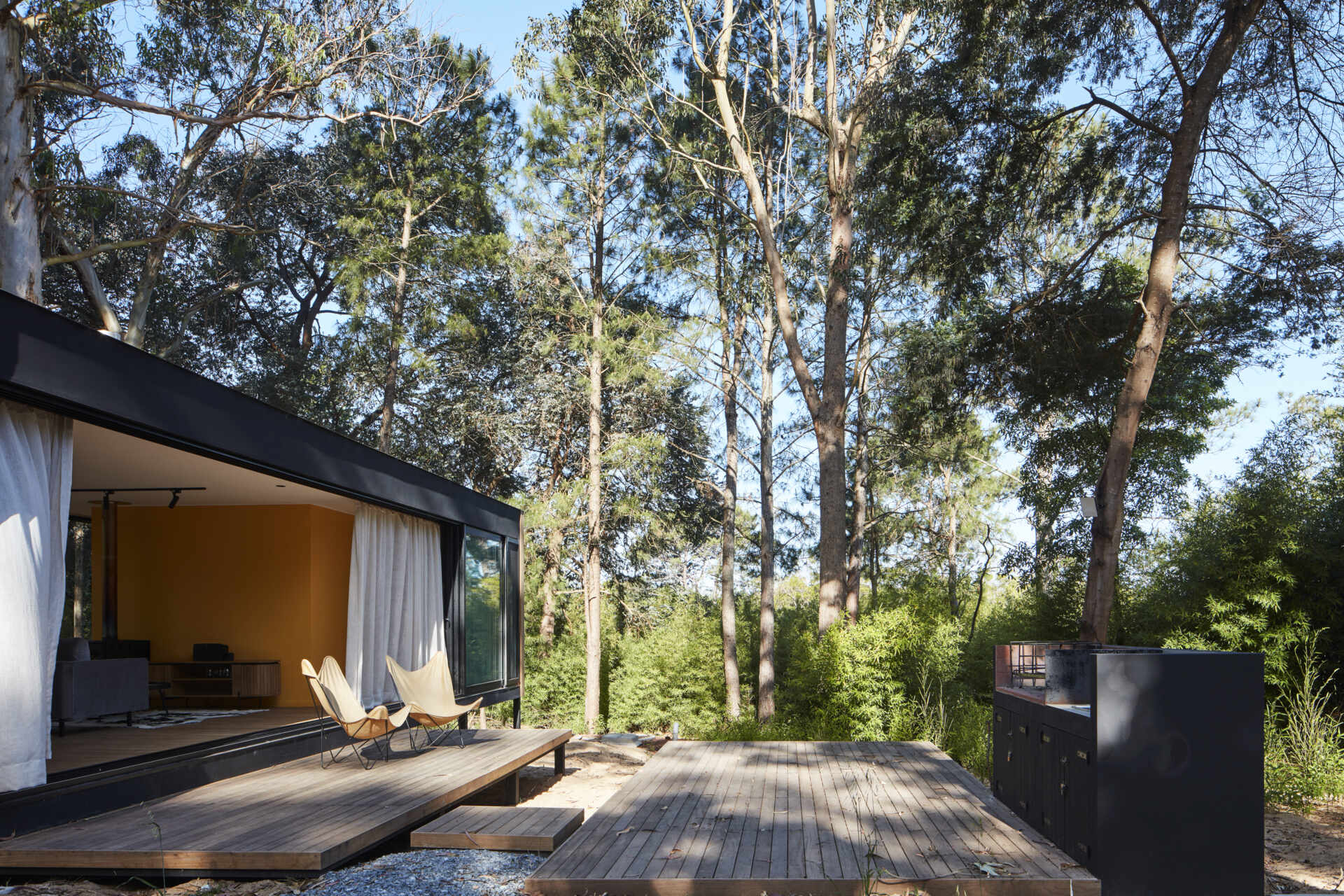 Drawing inspiration from mid-century single-family houses, this small forest home reinterprets classic ideas into a modern space where the inside and outside blend seamlessly.