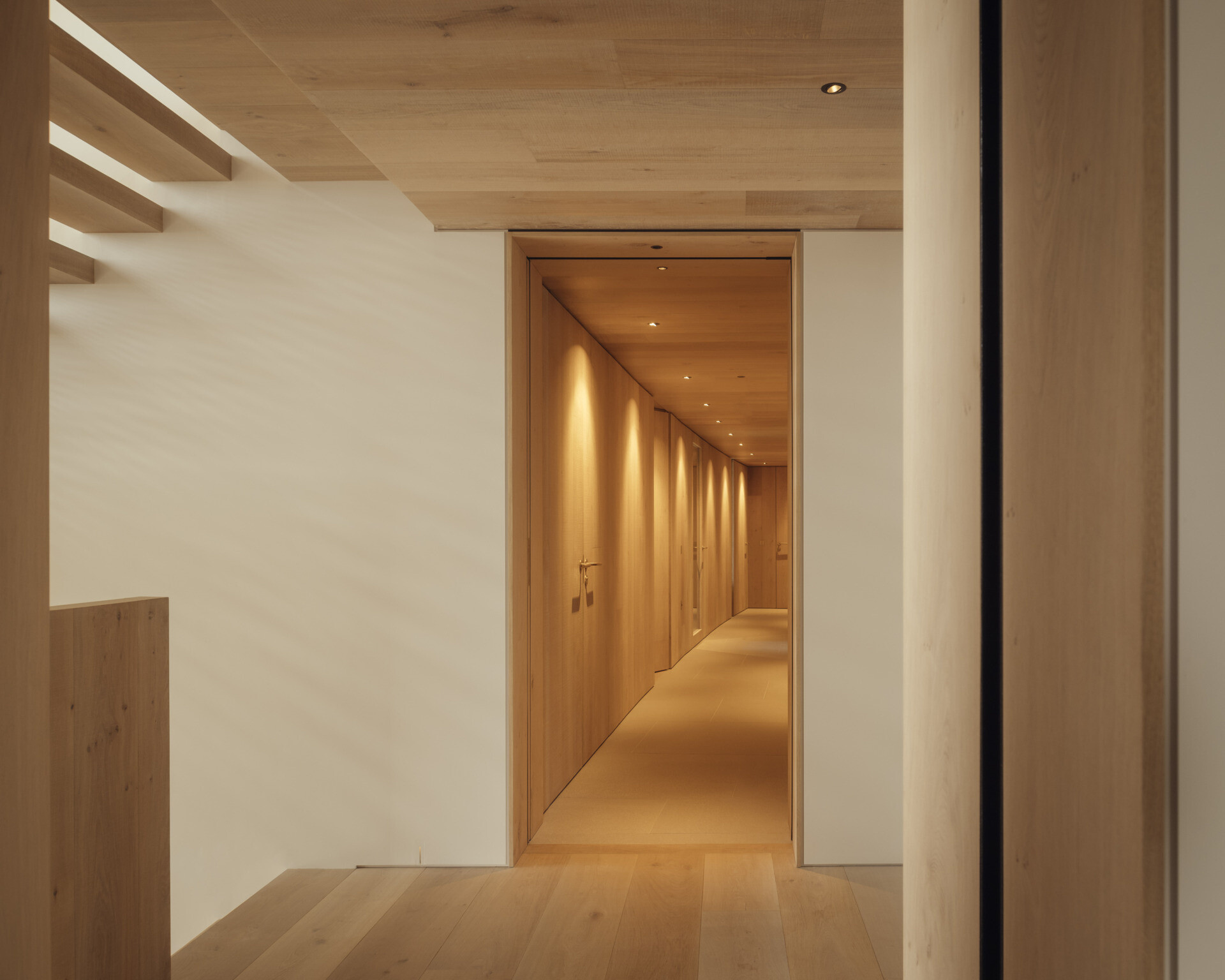 Circulation is designed as an experience. Deep inset windows and wood line the hallways, framing coastal and farmland views. Each transition through the home reveals new perspectives of the landscape.
