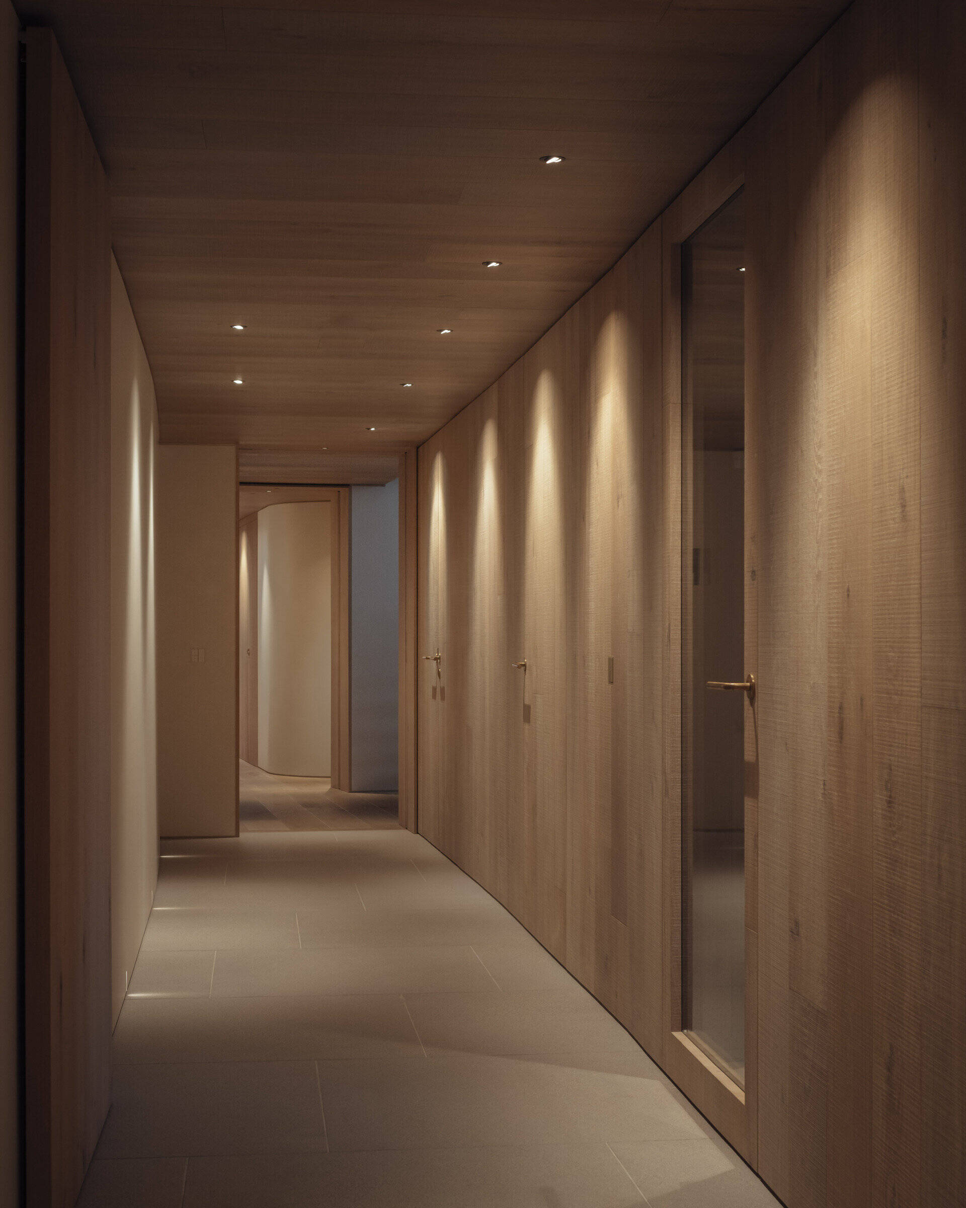 Circulation is designed as an experience. Deep inset windows and wood line the hallways, framing coastal and farmland views. Each transition through the home reveals new perspectives of the landscape.