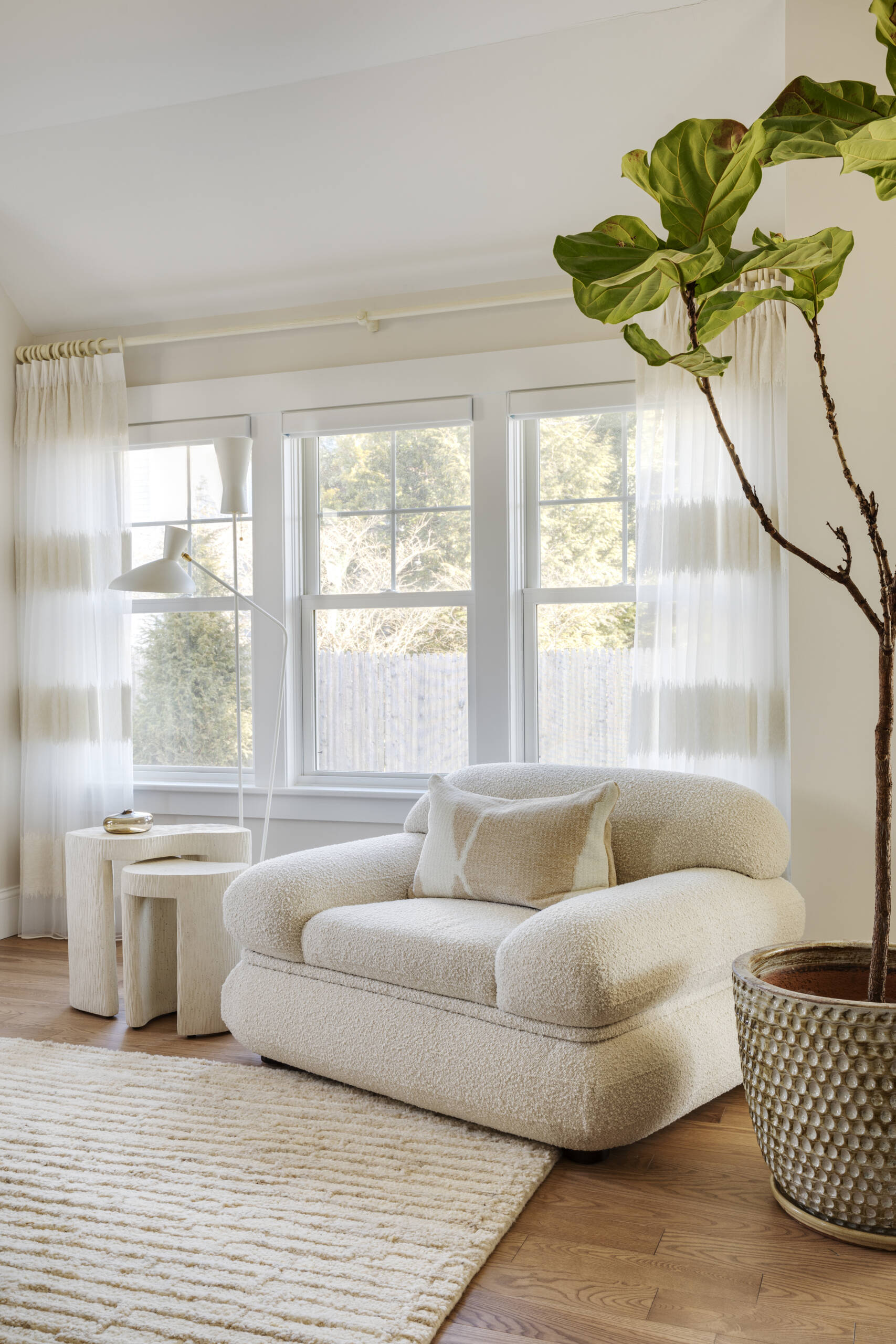 In the bedrooms of this Cape Cod home, the clients’ sentimental artwork was carefully reframed to give each piece a fresh, modern presence that complements the new design. Natural materials like wicker and rattan, gentle pops of green, and softly curved furniture tie the rooms to the coastal surroundings.