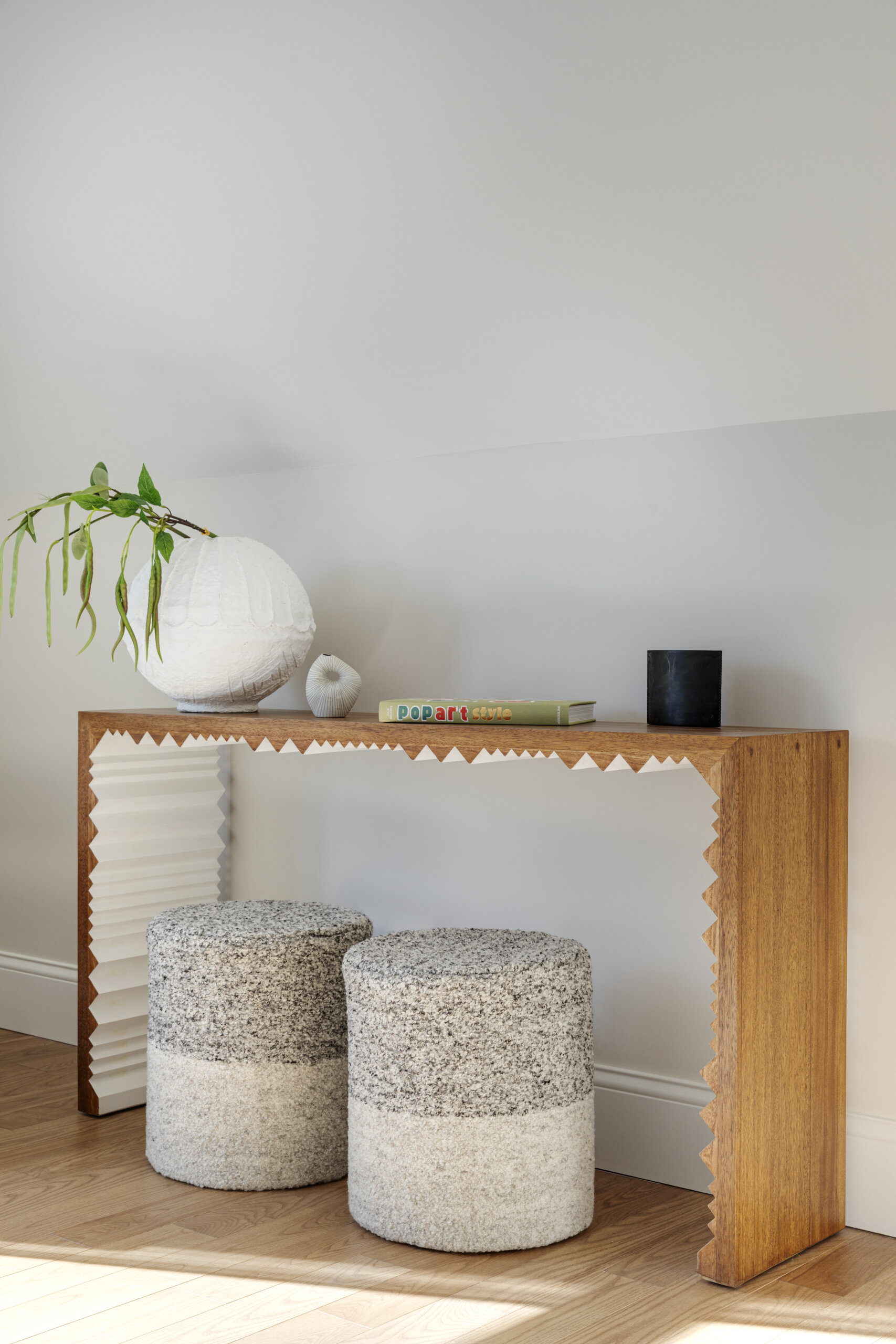 In the bedrooms of this Cape Cod home, the clients’ sentimental artwork was carefully reframed to give each piece a fresh, modern presence that complements the new design. Natural materials like wicker and rattan, gentle pops of green, and softly curved furniture tie the rooms to the coastal surroundings.