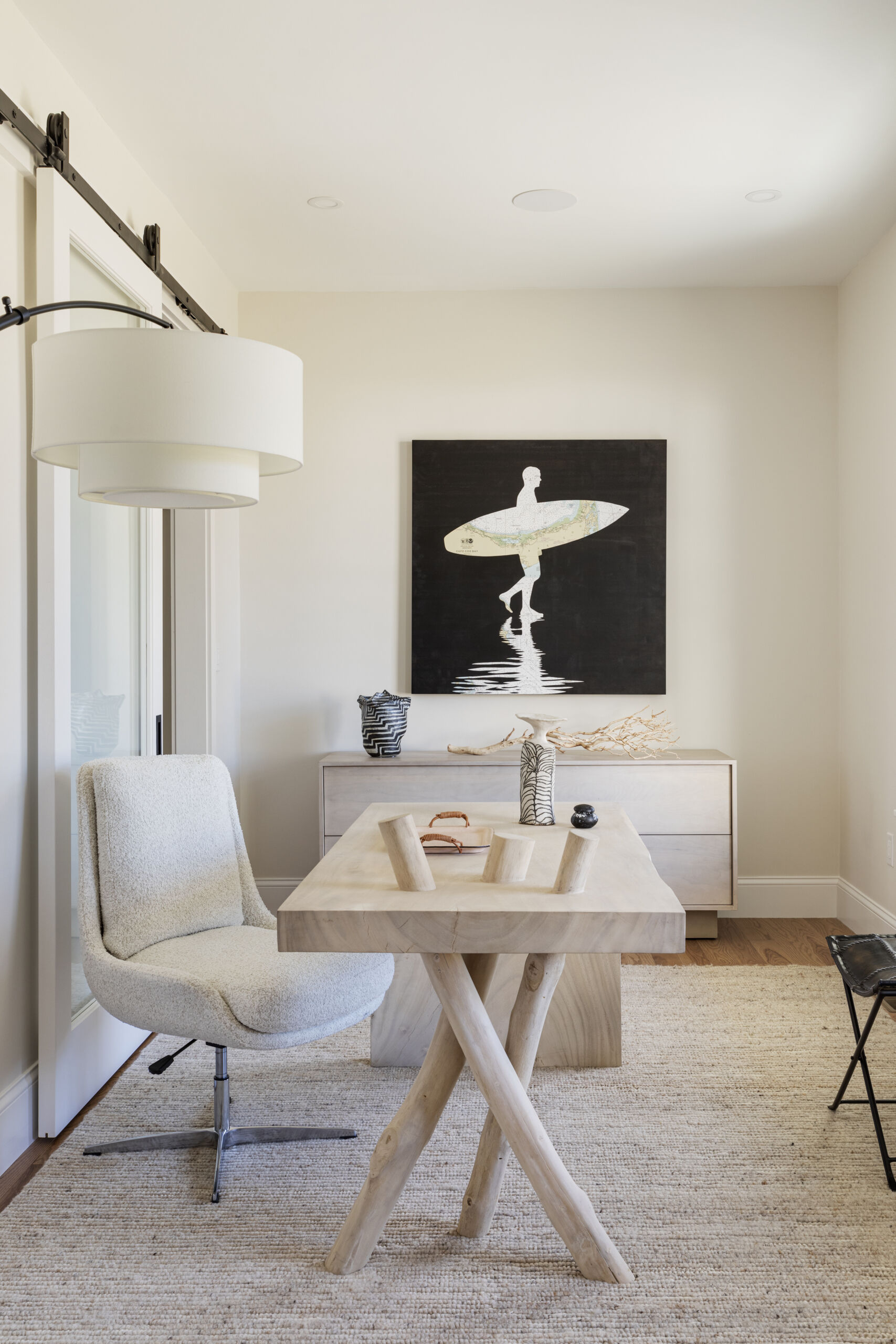 Sliding glass doors in the home office bring in natural light while keeping the space flexible.