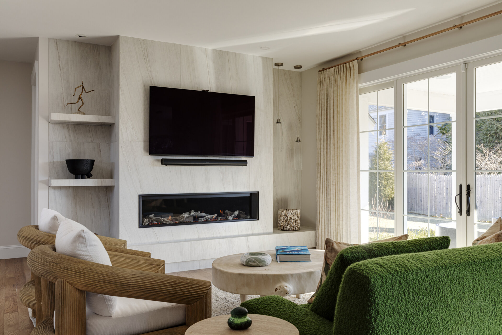 A Valor fireplace with Tiffany Crystal Alabaster tile anchors the living room in soft coastal hues.