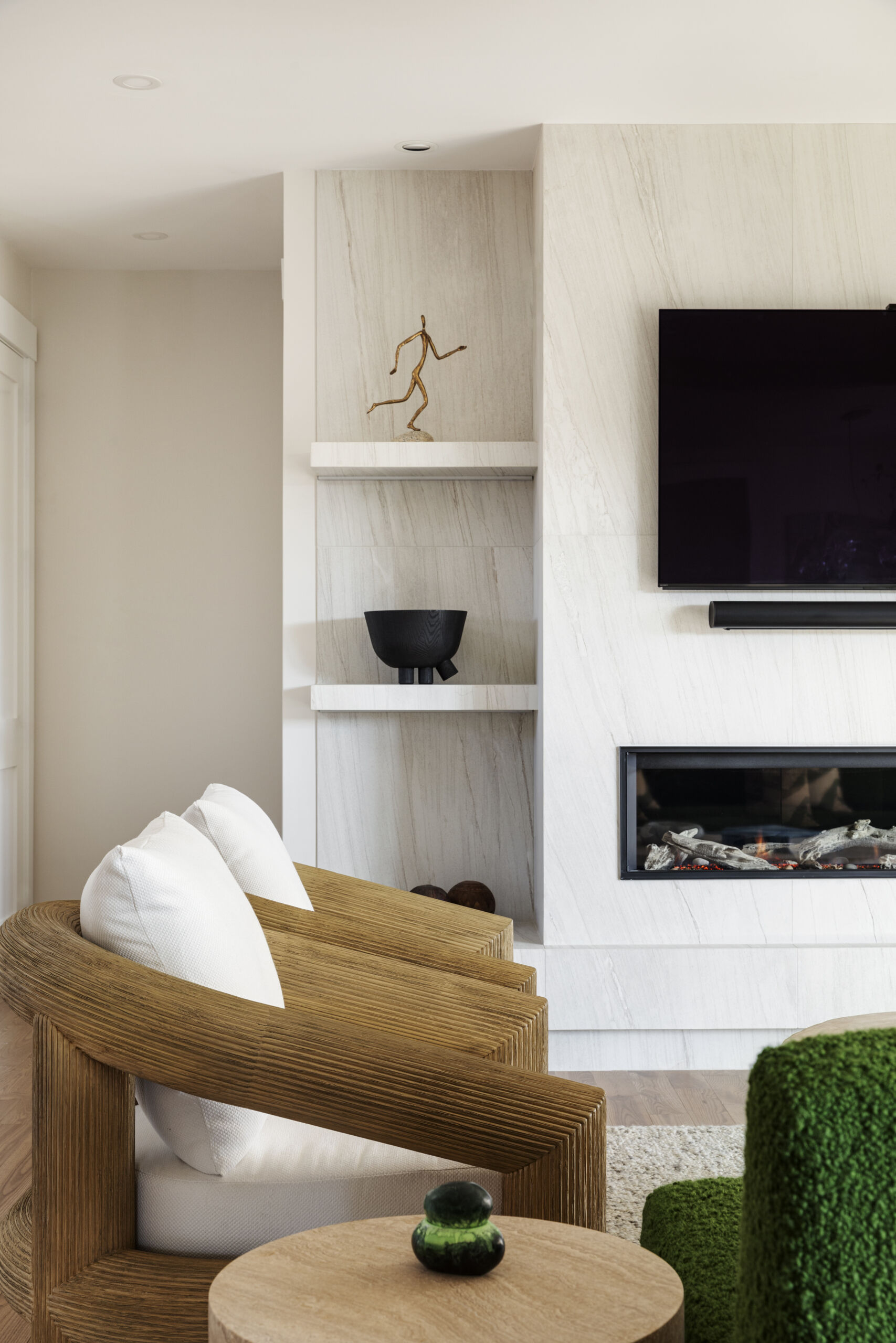 A Valor fireplace with Tiffany Crystal Alabaster tile anchors the living room in soft coastal hues.