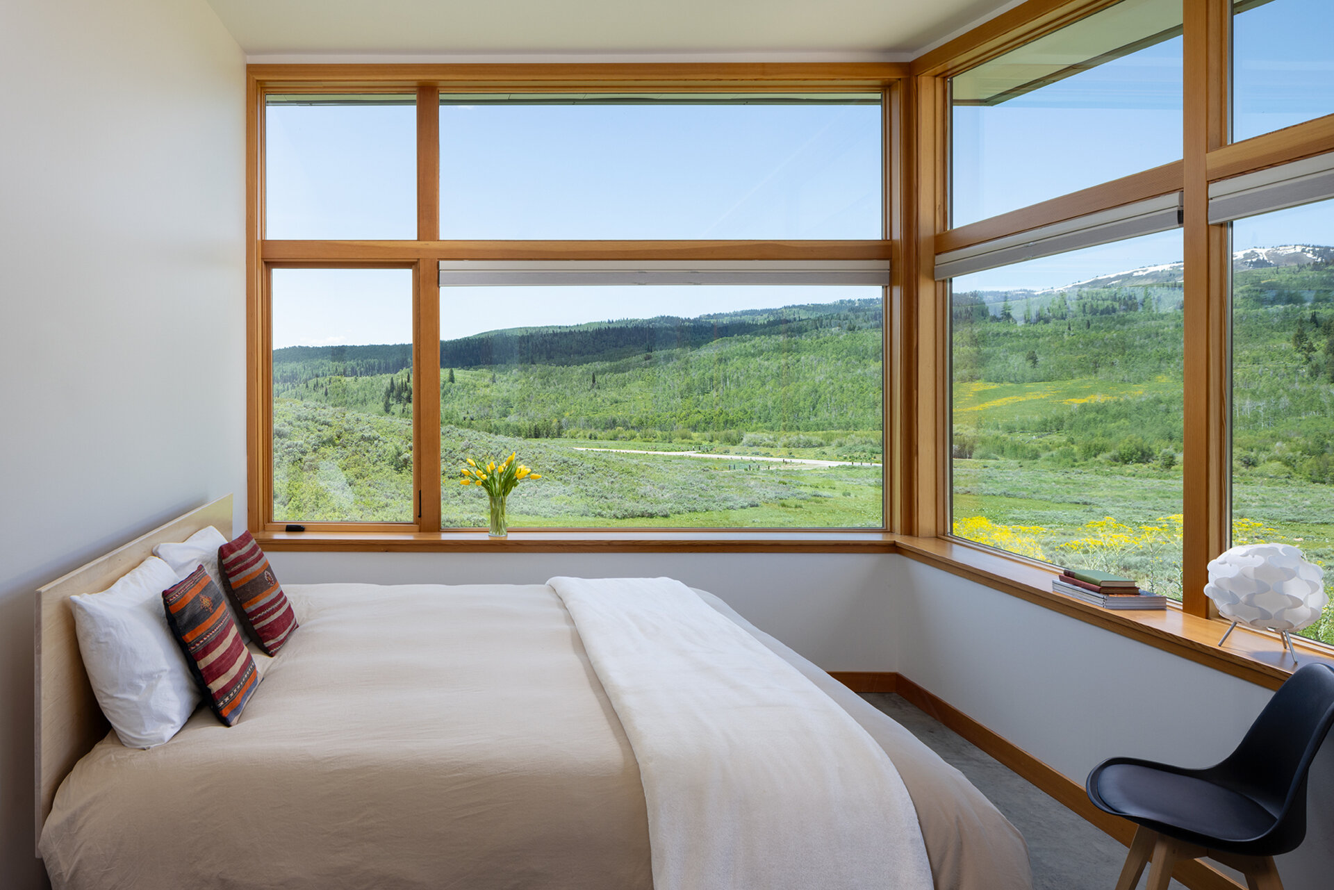Minimal finishes and natural materials create calming, durable bedrooms that connect with the home’s overall design.