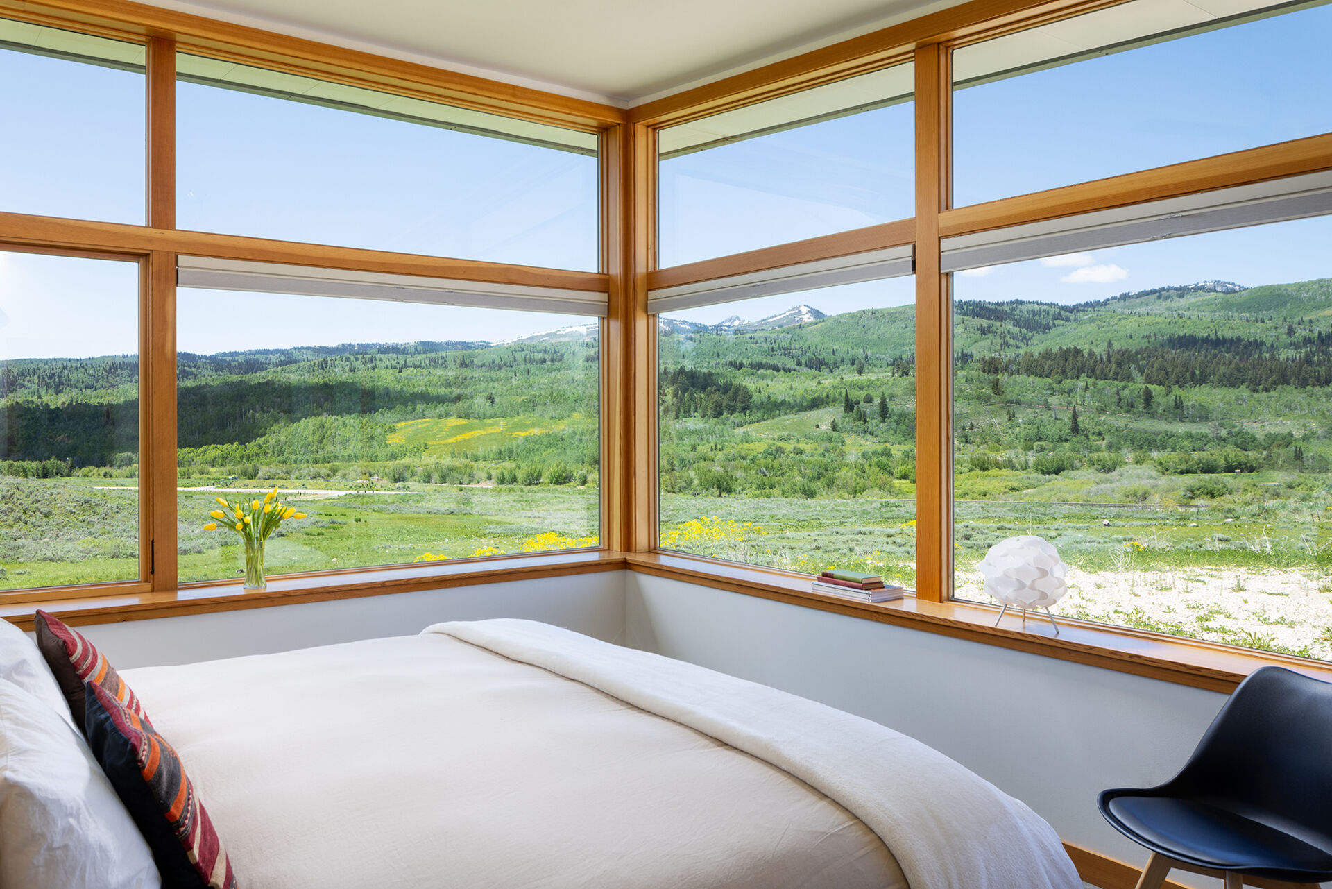 Minimal finishes and natural materials create calming, durable bedrooms that connect with the home’s overall design.