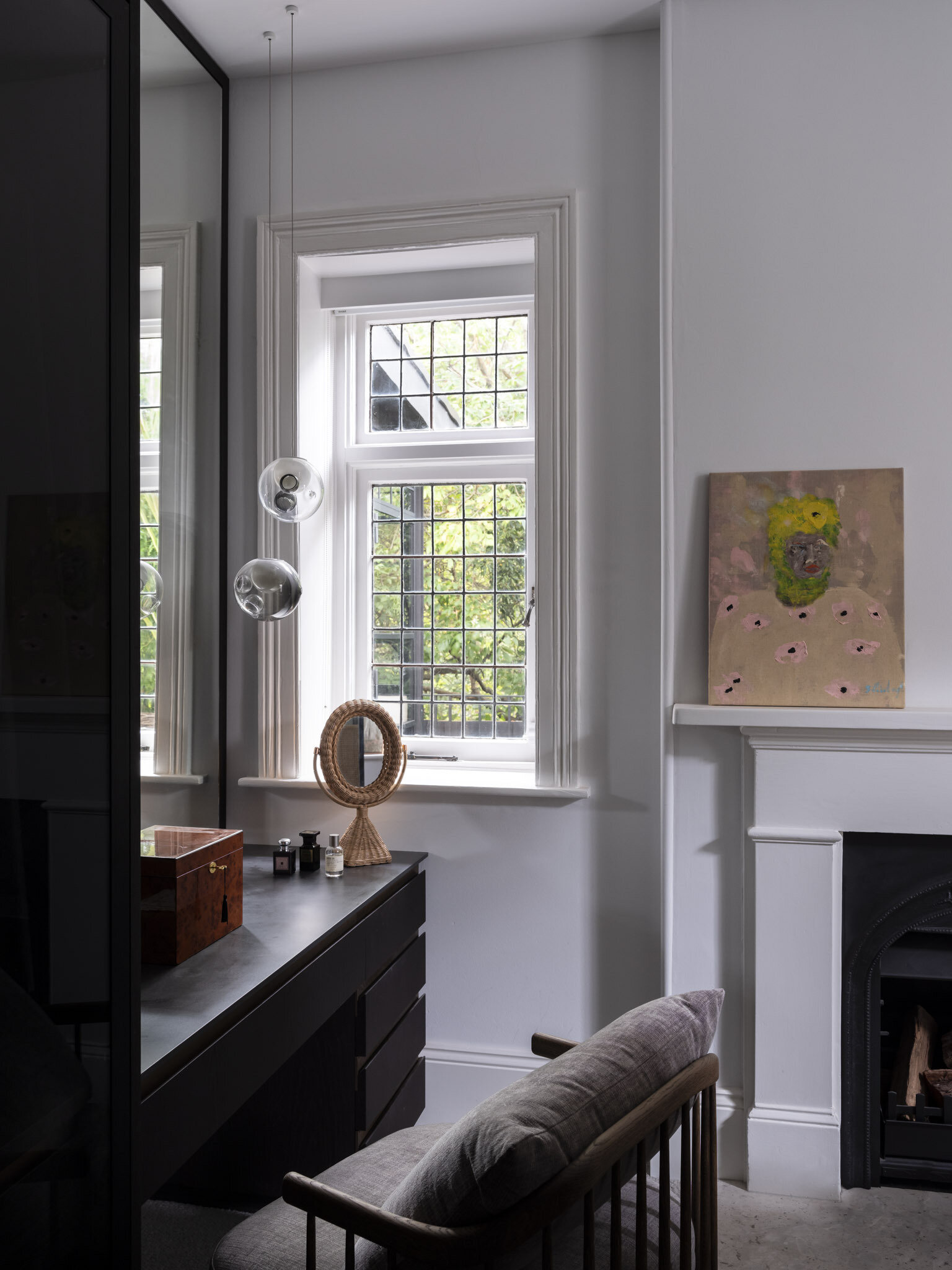 In the dressing room, the black accents complement the nearby bedroom and the bathroom.