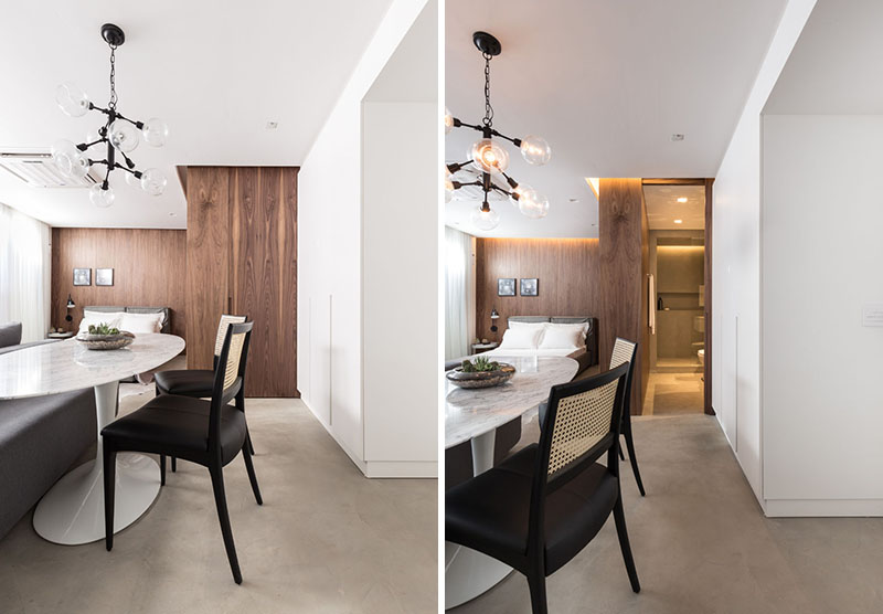 A door within a wood accent wall hides the bathroom.
