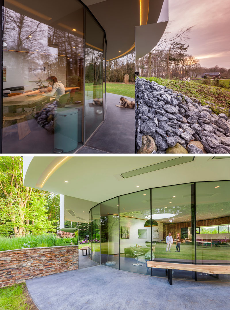 Tucked into a hillside, this home’s circular shape minimizes its footprint and blends seamlessly into the forest. Circular windows wrap around half the house, while mirrored walls at each end create the illusion of endless glass. 