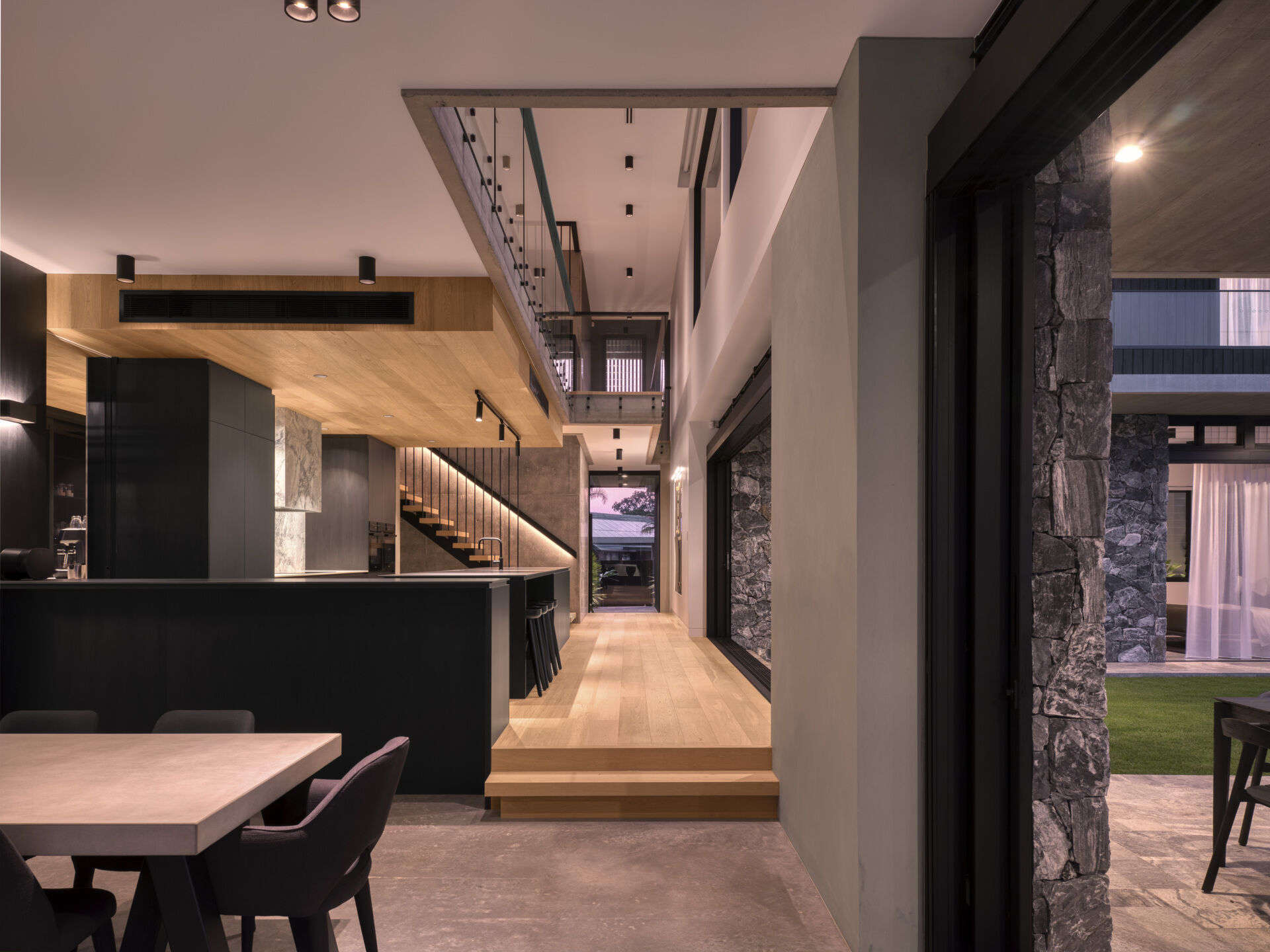 The kitchen as well as the dining area, opens to the central courtyard, making it a bright, social hub. Natural ventilation and daylight ensure the space remains comfortable throughout the day. Layered greenery and thoughtful detailing create a calm, inviting atmosphere where family meals feel connected to the surrounding landscape.