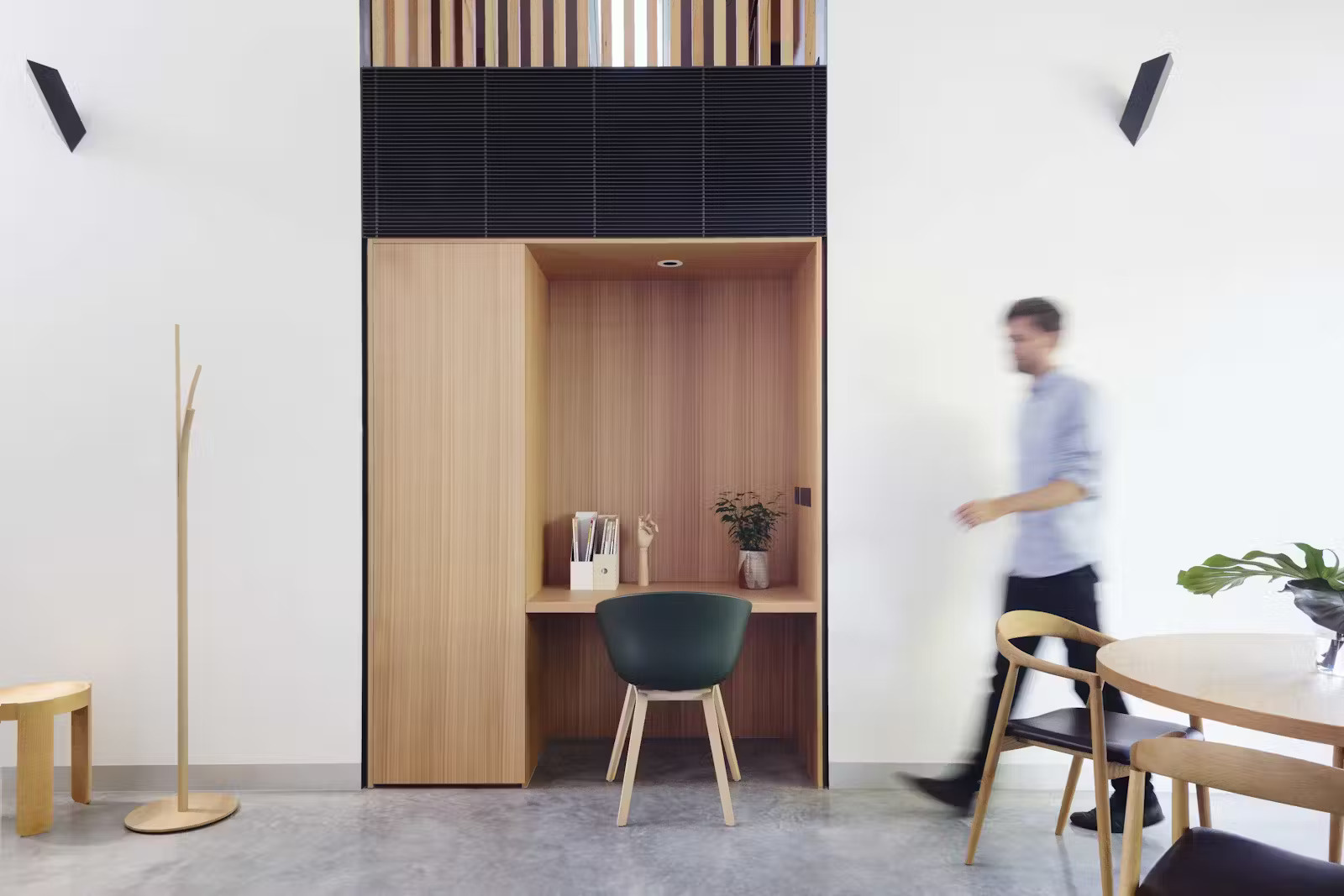 White walls and pale wood cabinetry keep these Melbourne apartments light, open, and calming, perfect for small-space living.