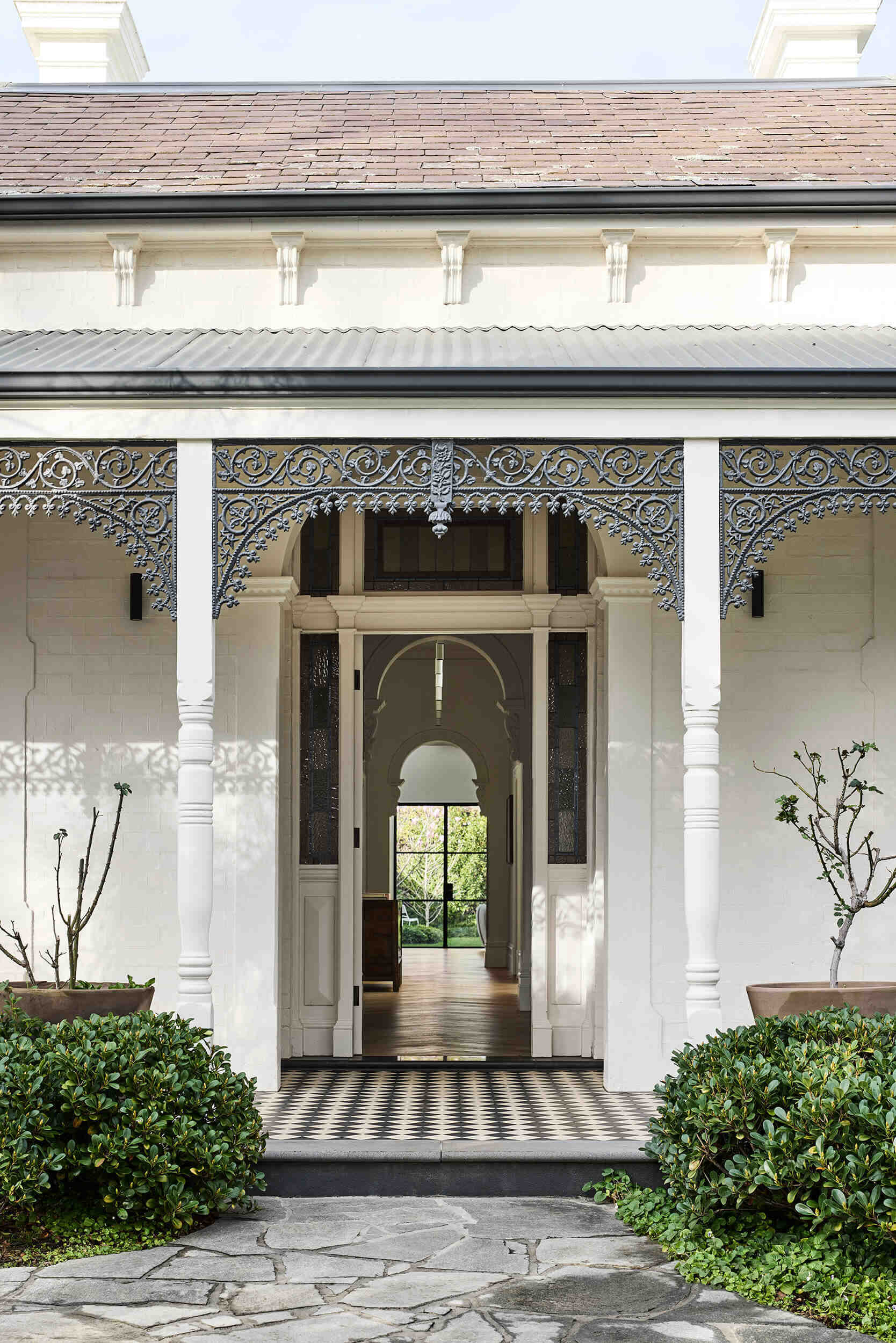 This Melbourne residence combines a restored Victorian facade with dark timber and glass for a seamless modern contrast.