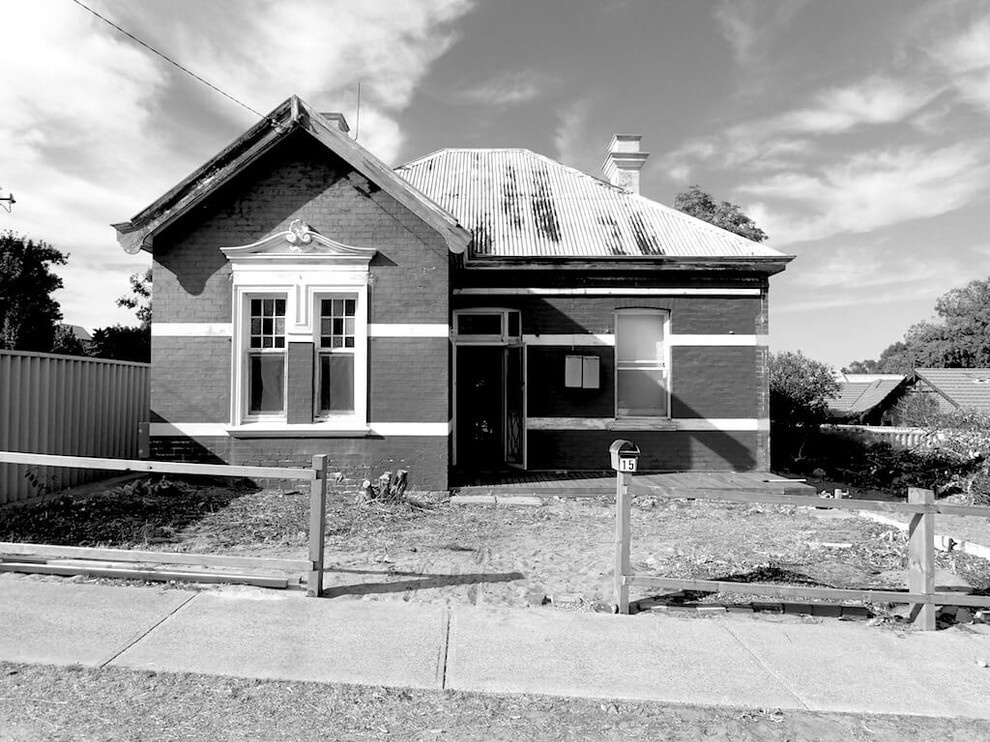 BEFORE THE RENOVATION - A striking contrast between old and new defines this Australian heritage home renovation, featuring a dark modern extension and sleek carport