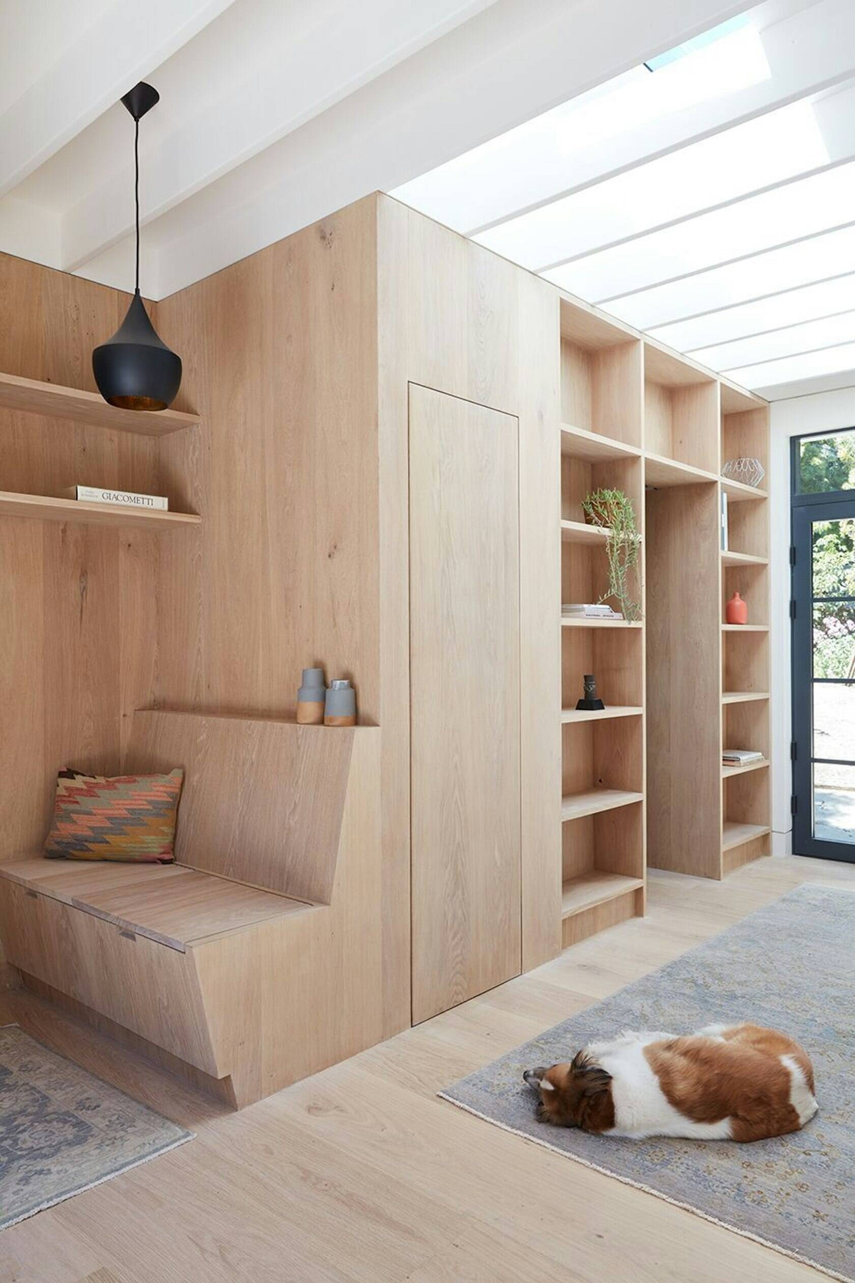 White oak panels and floating shelves define the serene interior of this converted carriage house in San Francisco.