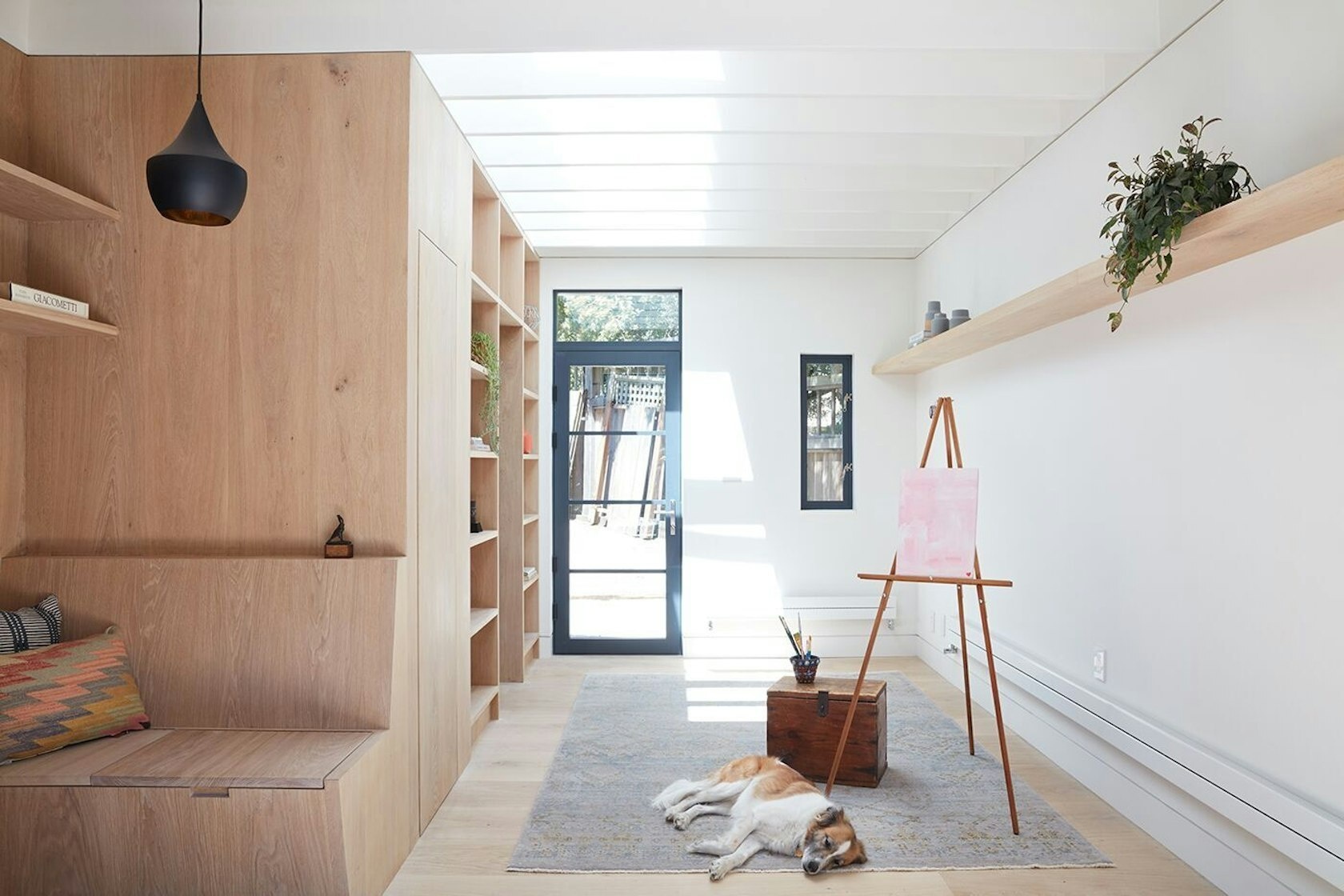 White oak panels and floating shelves define the serene interior of this converted carriage house in San Francisco.