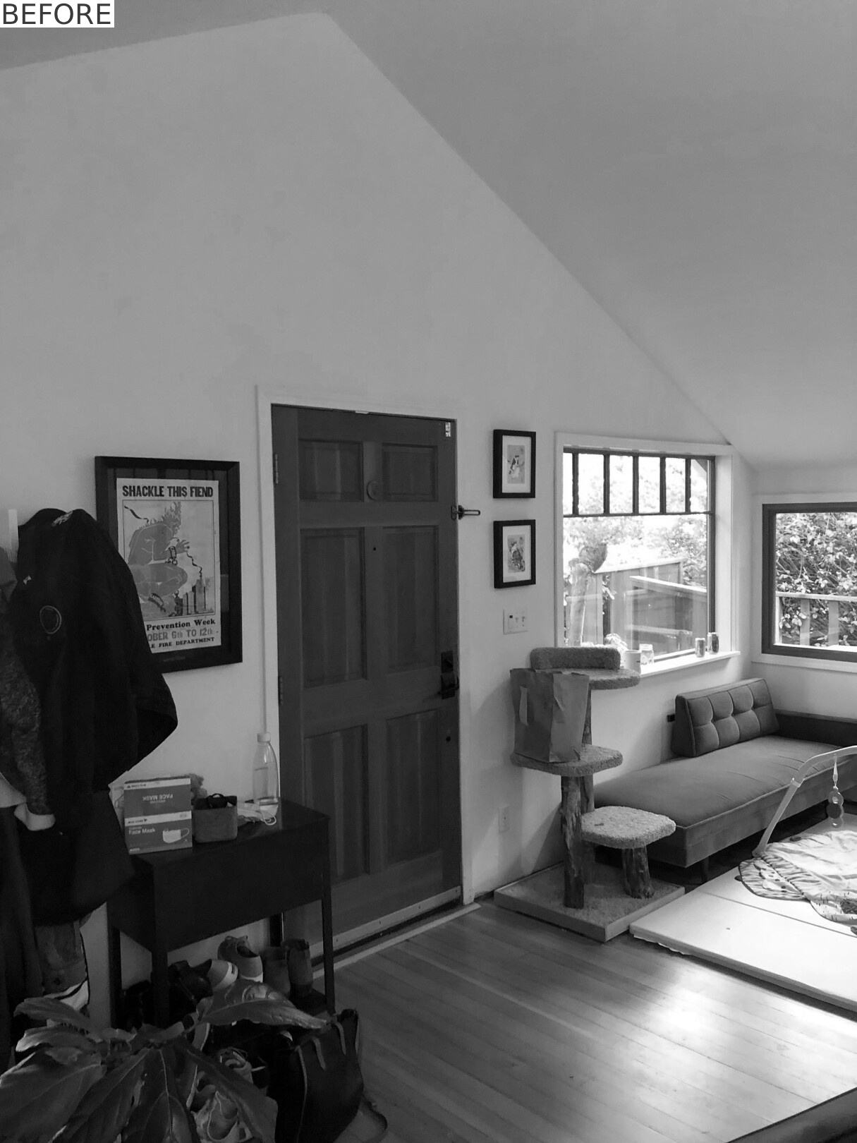 BEFORE - Open living and dining spaces now feature coral-painted steel beams and floor-to-ceiling bookshelves.