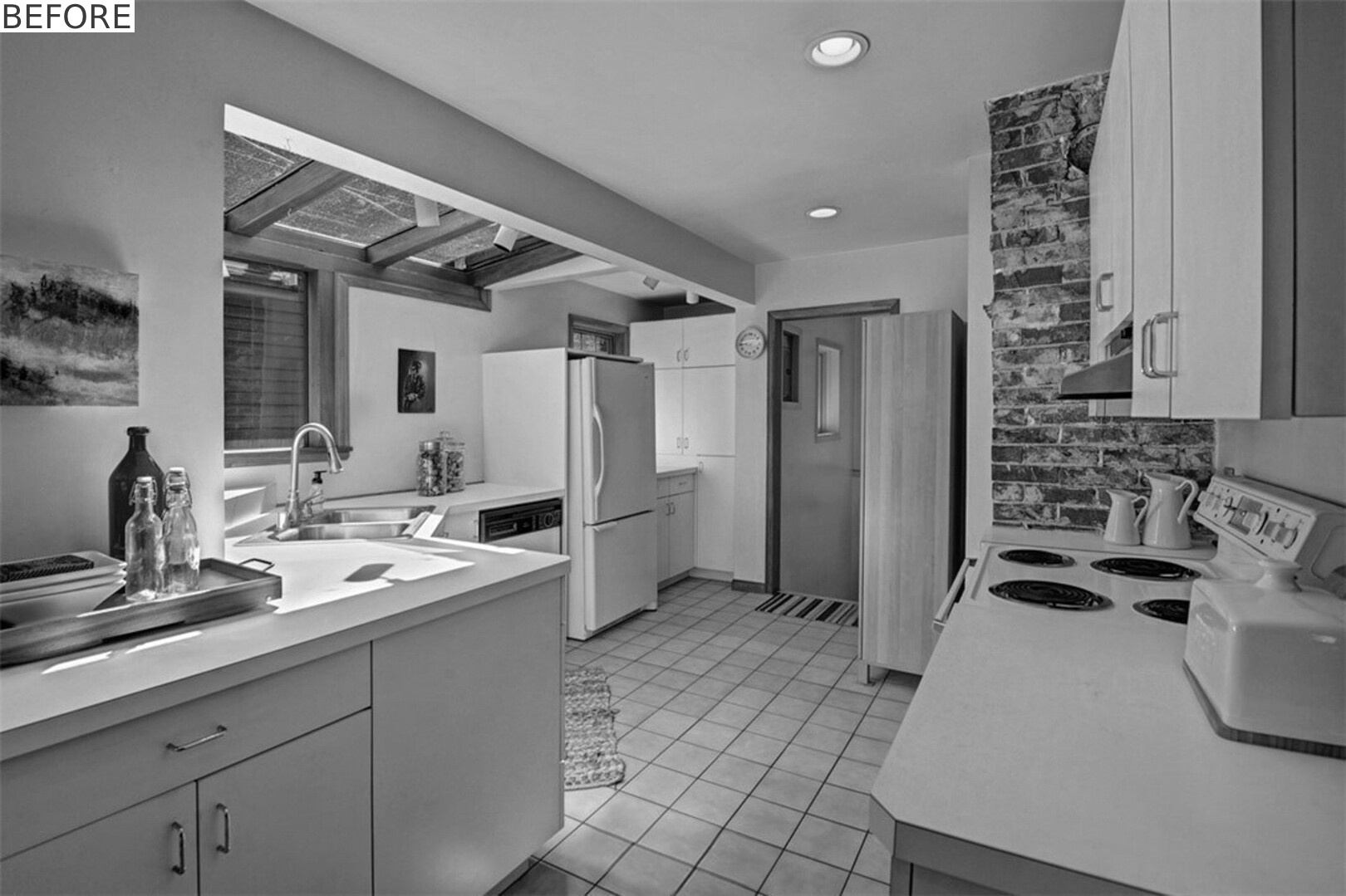 BEFORE - The updated kitchen flows into the dining nook with fresh cabinetry, tile, and appliances.