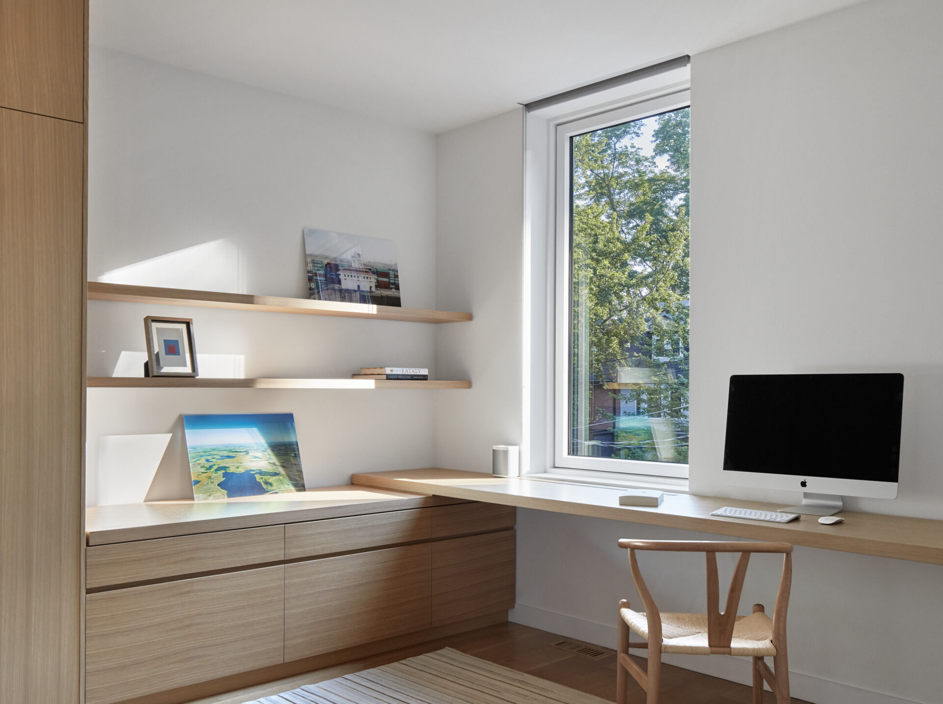Upstairs workspaces with clever built-ins show how minimalist design can feel family-friendly.