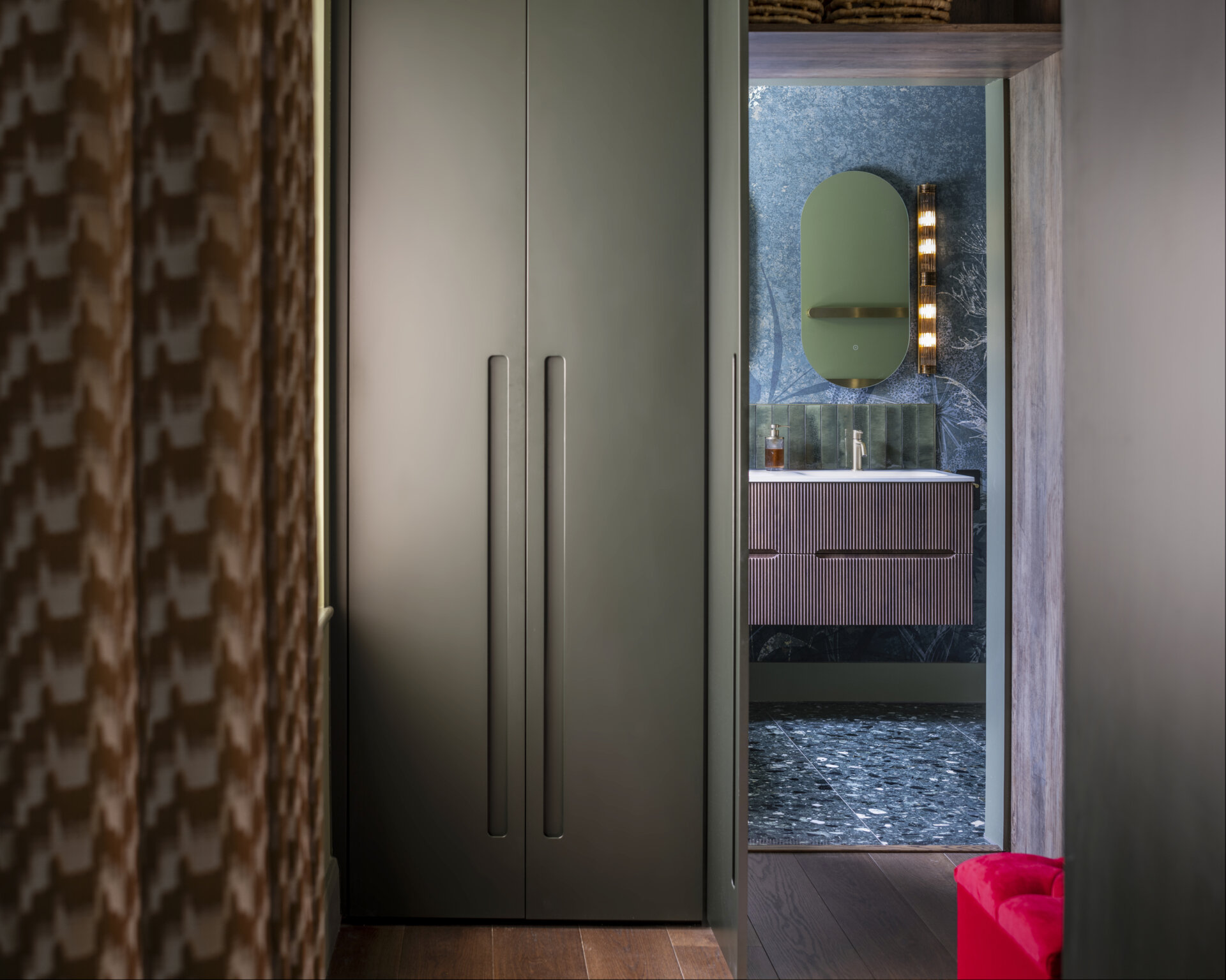 The main bedroom suite embodies comfort and calm. A walk-through closet leads to a serene ensuite bathroom, finished in soft tones that complement the home’s palette.