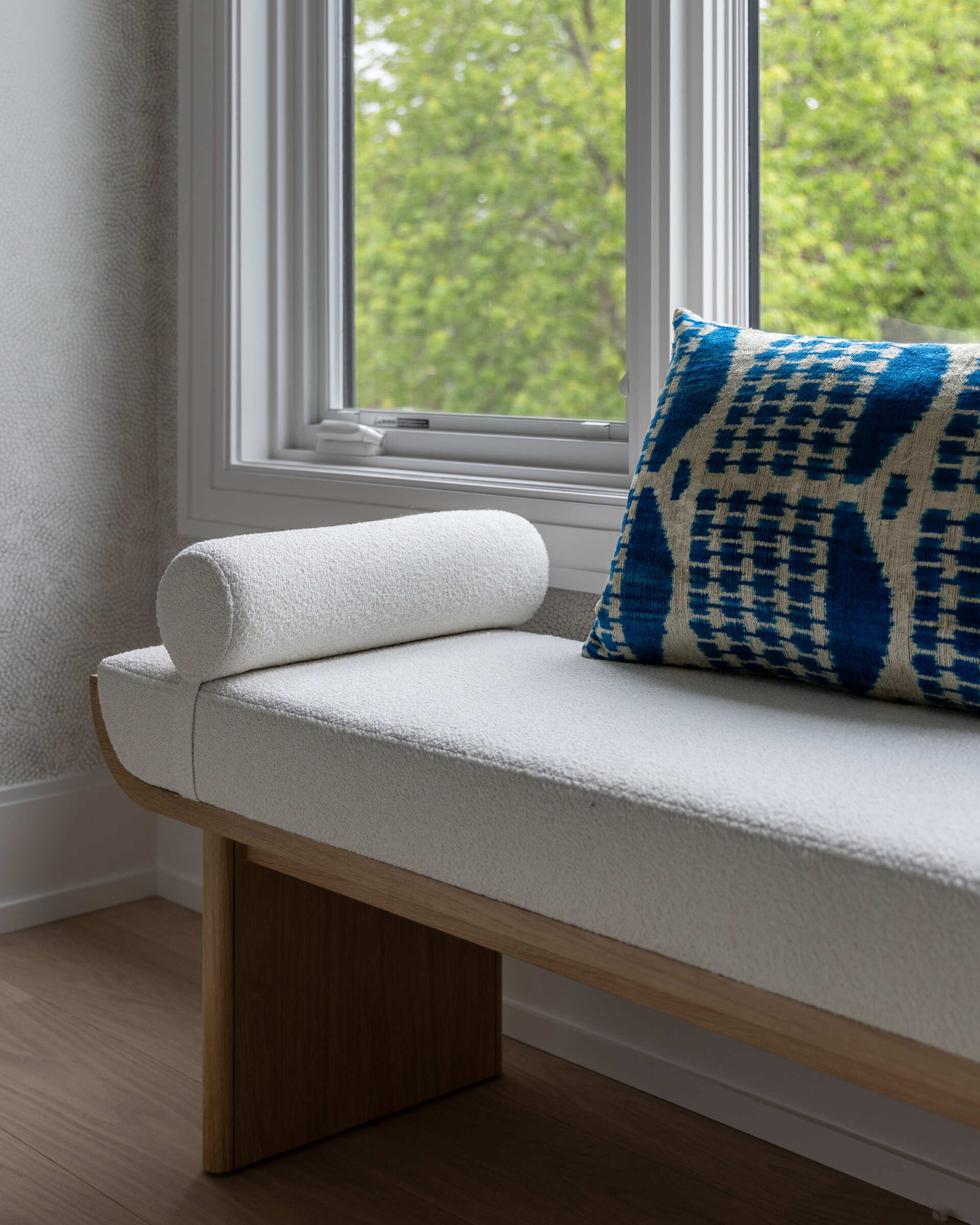 Contemporary bedroom with bench by the window.