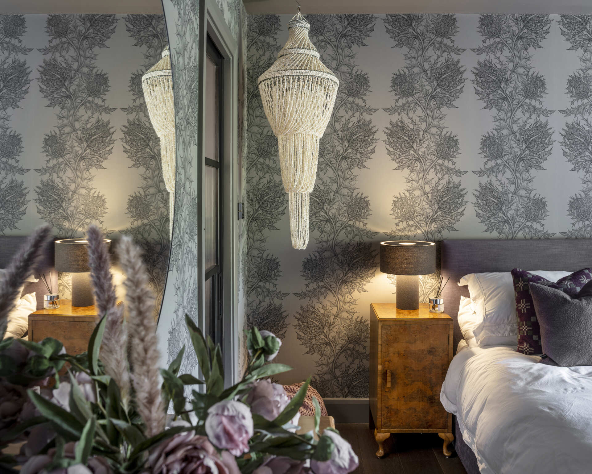 A second bedroom is luxurious with subtle colors of deep purples and black.