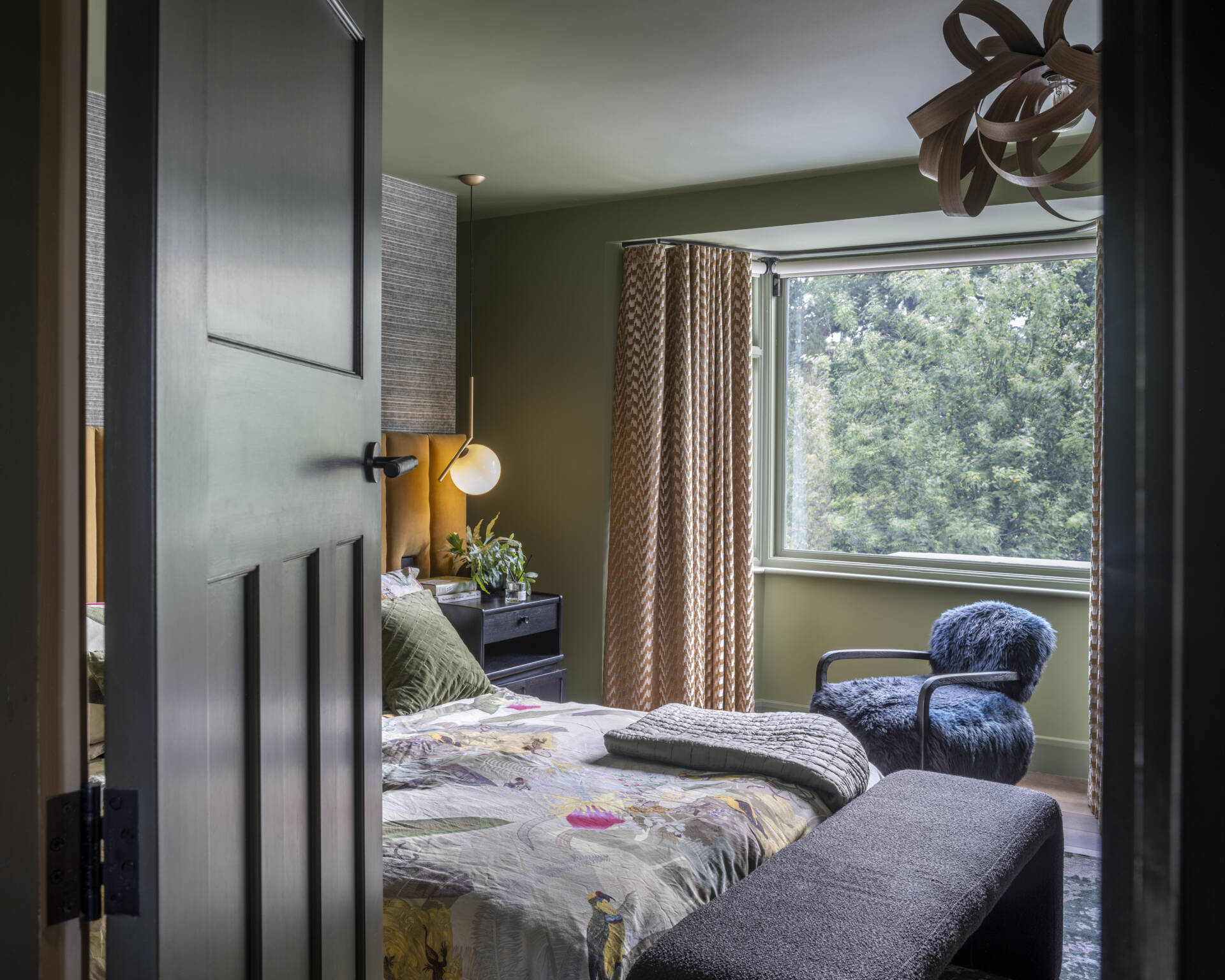 The main bedroom suite embodies comfort and calm. A walk-through closet leads to a serene ensuite bathroom, finished in soft tones that complement the home’s palette.