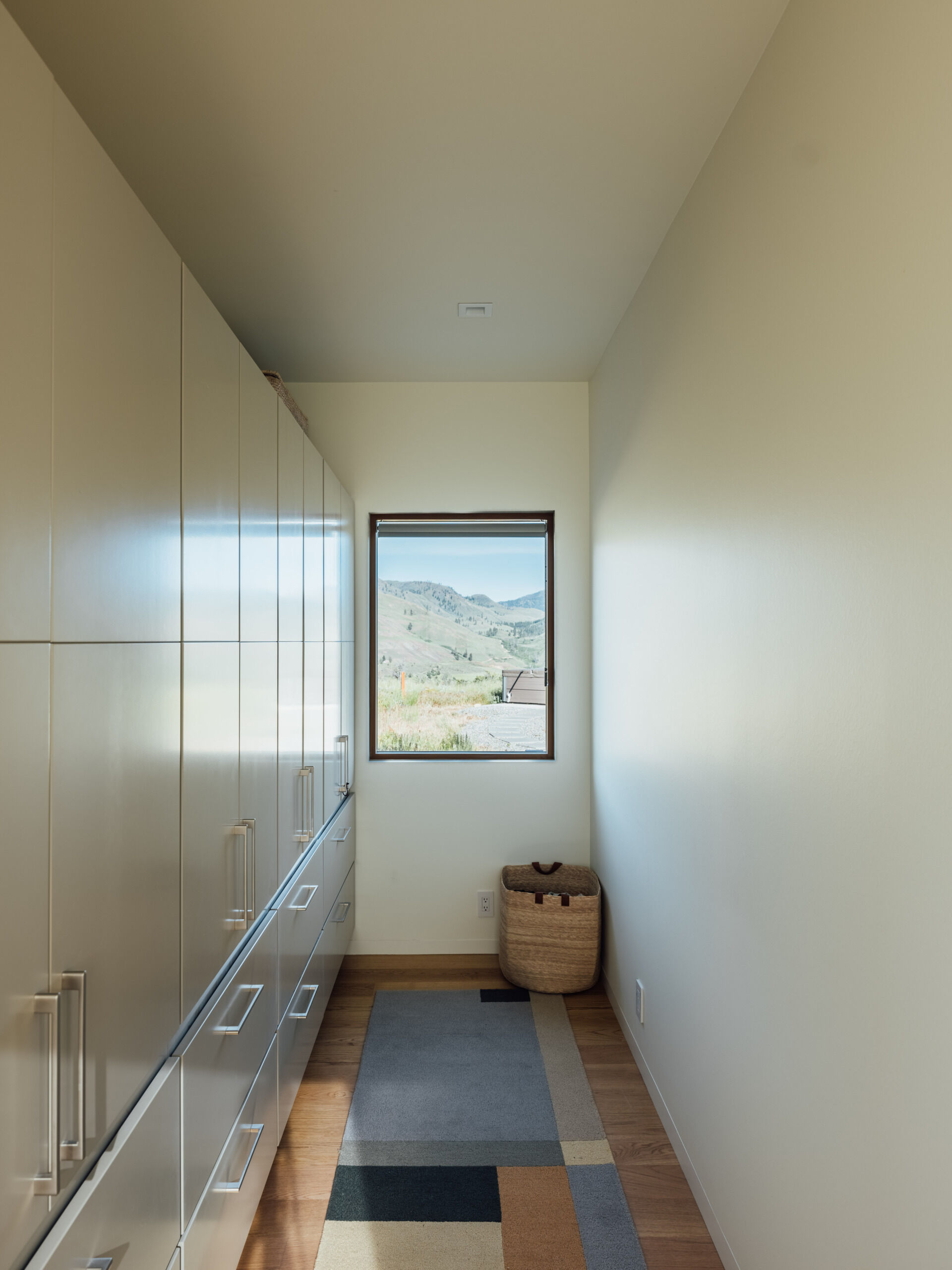 Simple lines define the closet’s built-in elegance. It’s practical, beautifully crafted, and perfectly aligned with the home’s ethos of understated design.