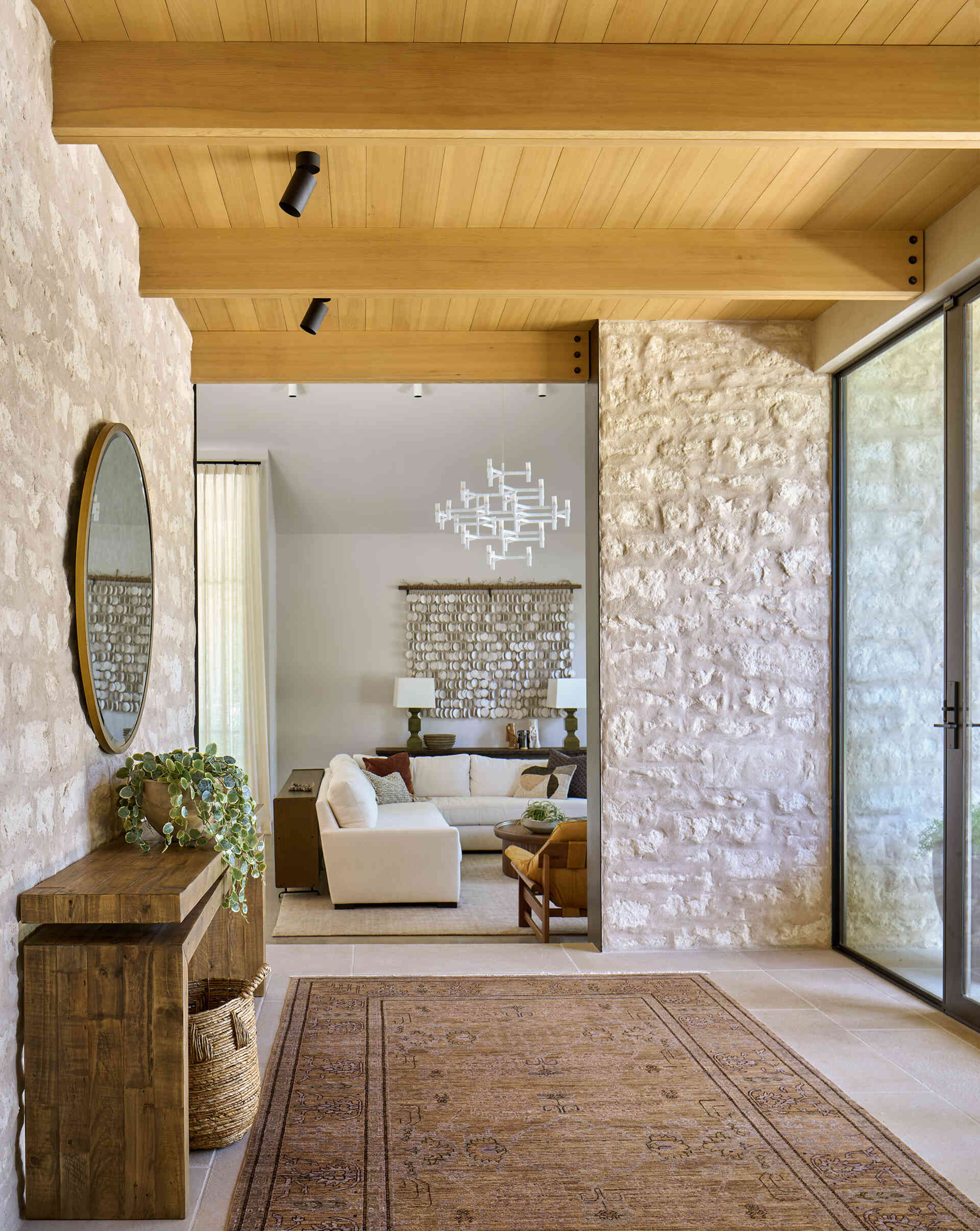 The entryway frames the preserved oak tree, a design decision that defines the architecture and interiors