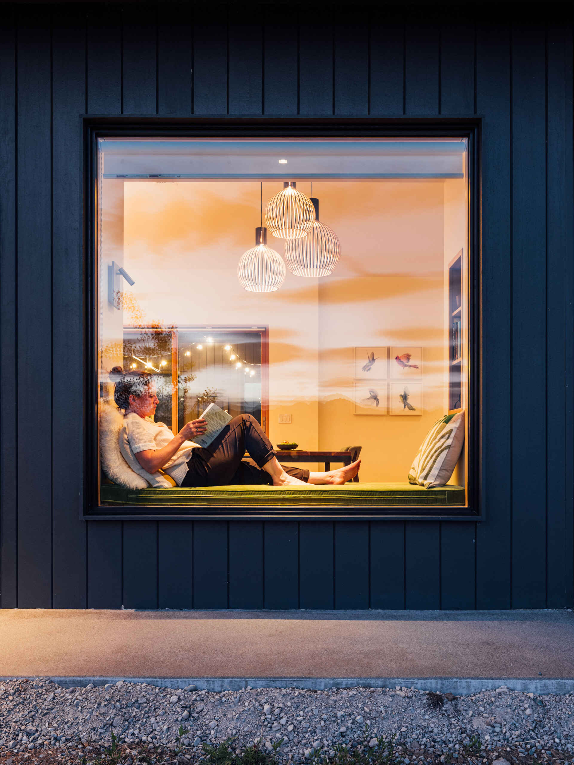 A single built-in window seat captures the heart of this Washington home. Warm wood, soft cushions, and a perfectly framed mountain view make it the most irresistible place to pause and breathe.