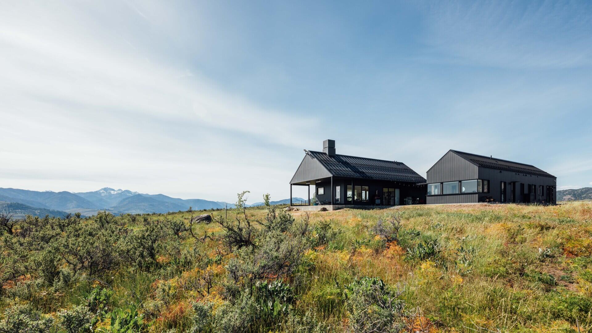 Two matte-black gabled volumes stand quietly against the Methow Valley landscape. The design by Syndicate Smith trades glass walls for carefully framed openings, creating a modern home that feels both grounded and deliberate.