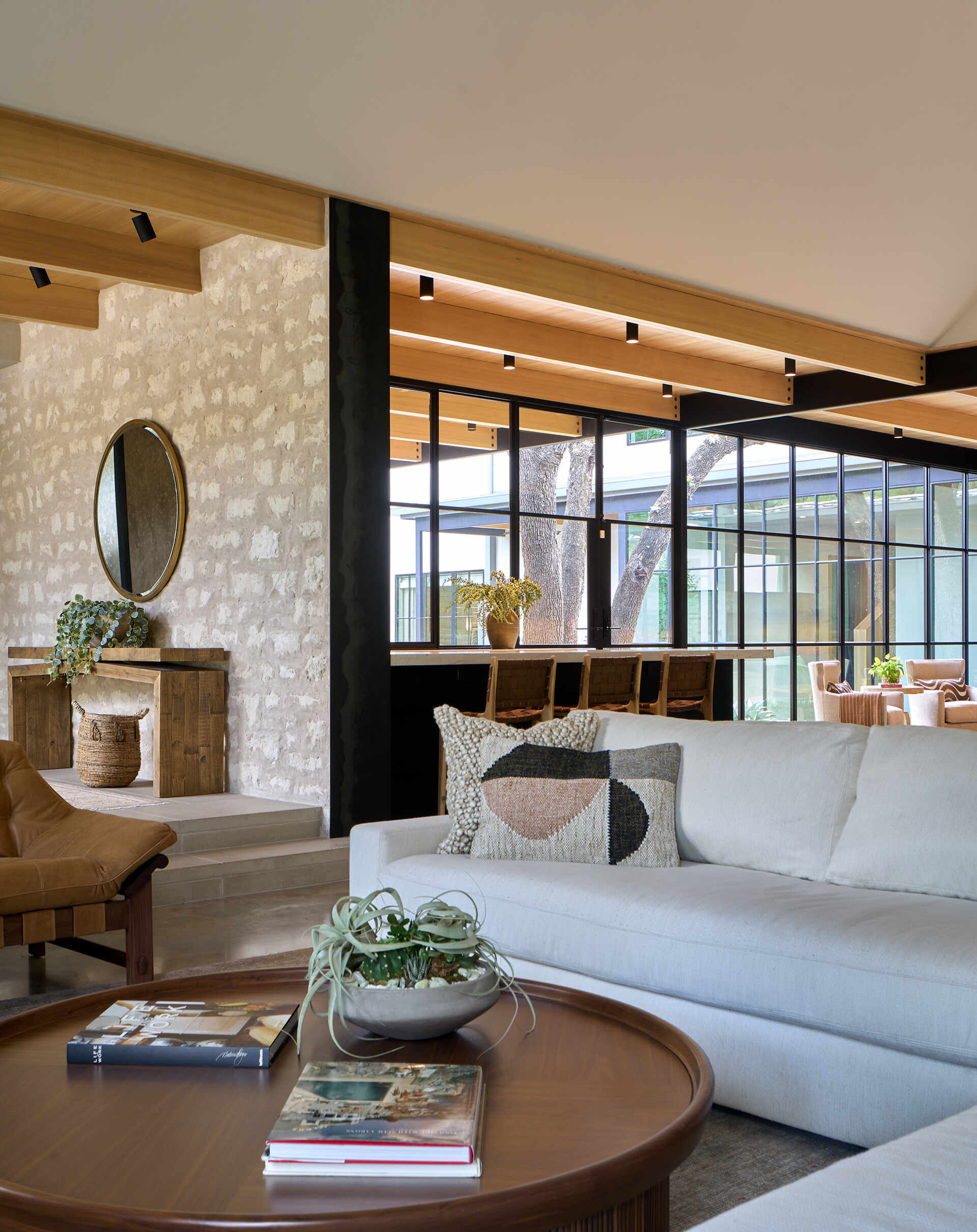 A modern interior with a wood ceiling and stone walls.