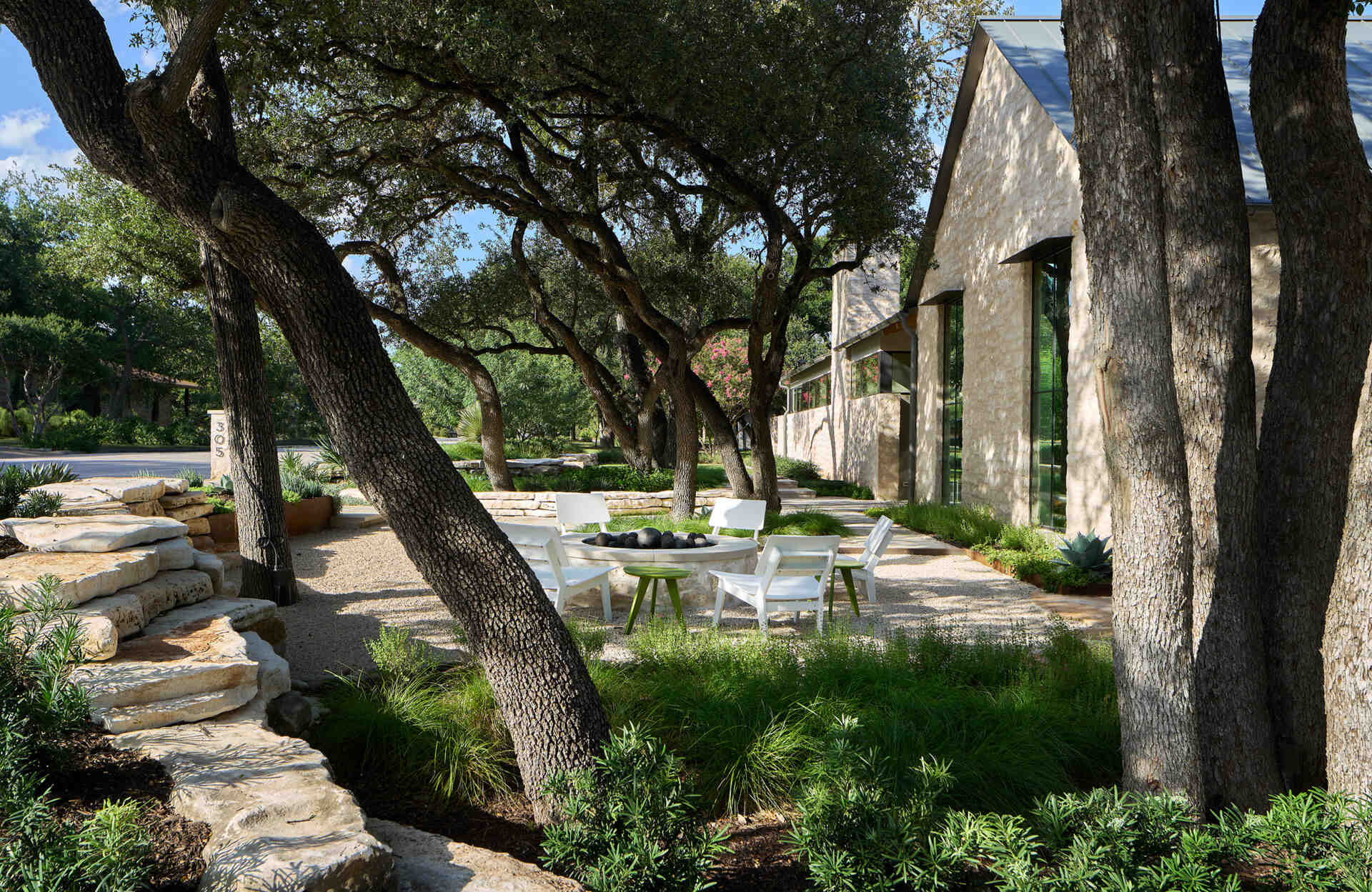 A modest street view hides a courtyard home filled with natural light, limestone, and wood by Furman & Keil Architects.