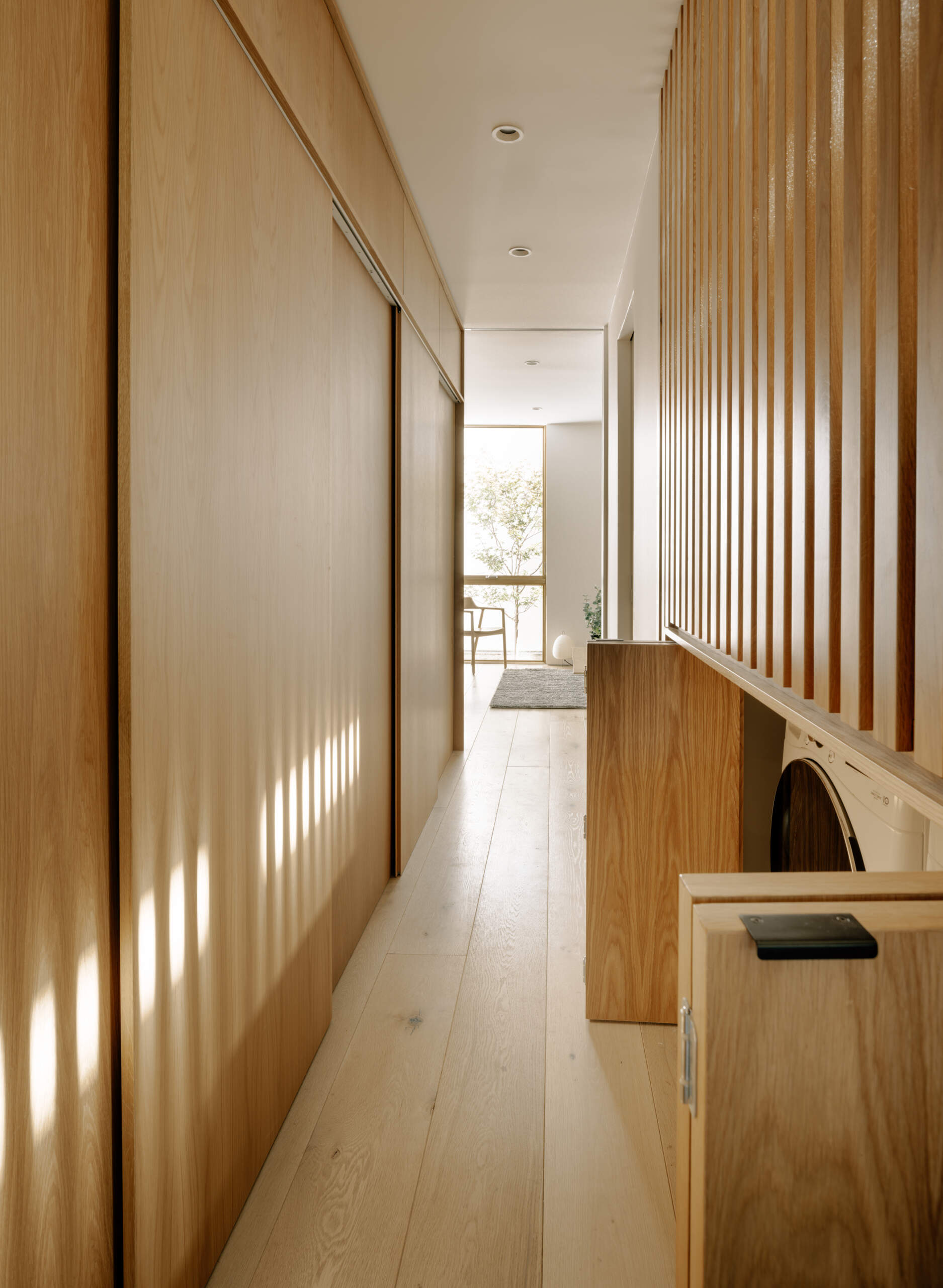 Strategically located along circulation paths, the hidden laundry supports daily routines without disrupting the flow of the home. Its discreet placement demonstrates thoughtful planning for functional, flexible family living.