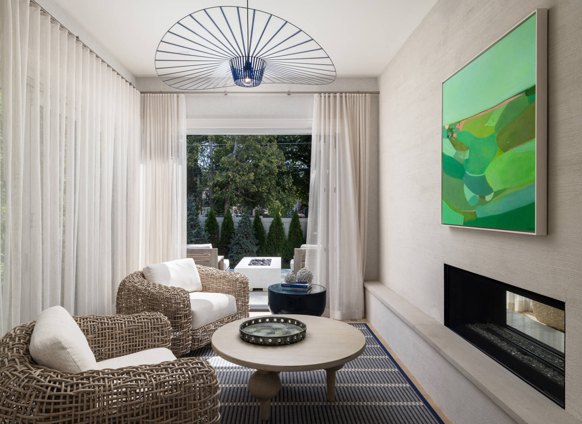 Slide the glass wide and the living space keeps going. The lanai picks up the home’s palette, so there is no harsh break between inside and out. You get firepit nights, breezy lunches, and that rare sense that the house is relaxing with you.