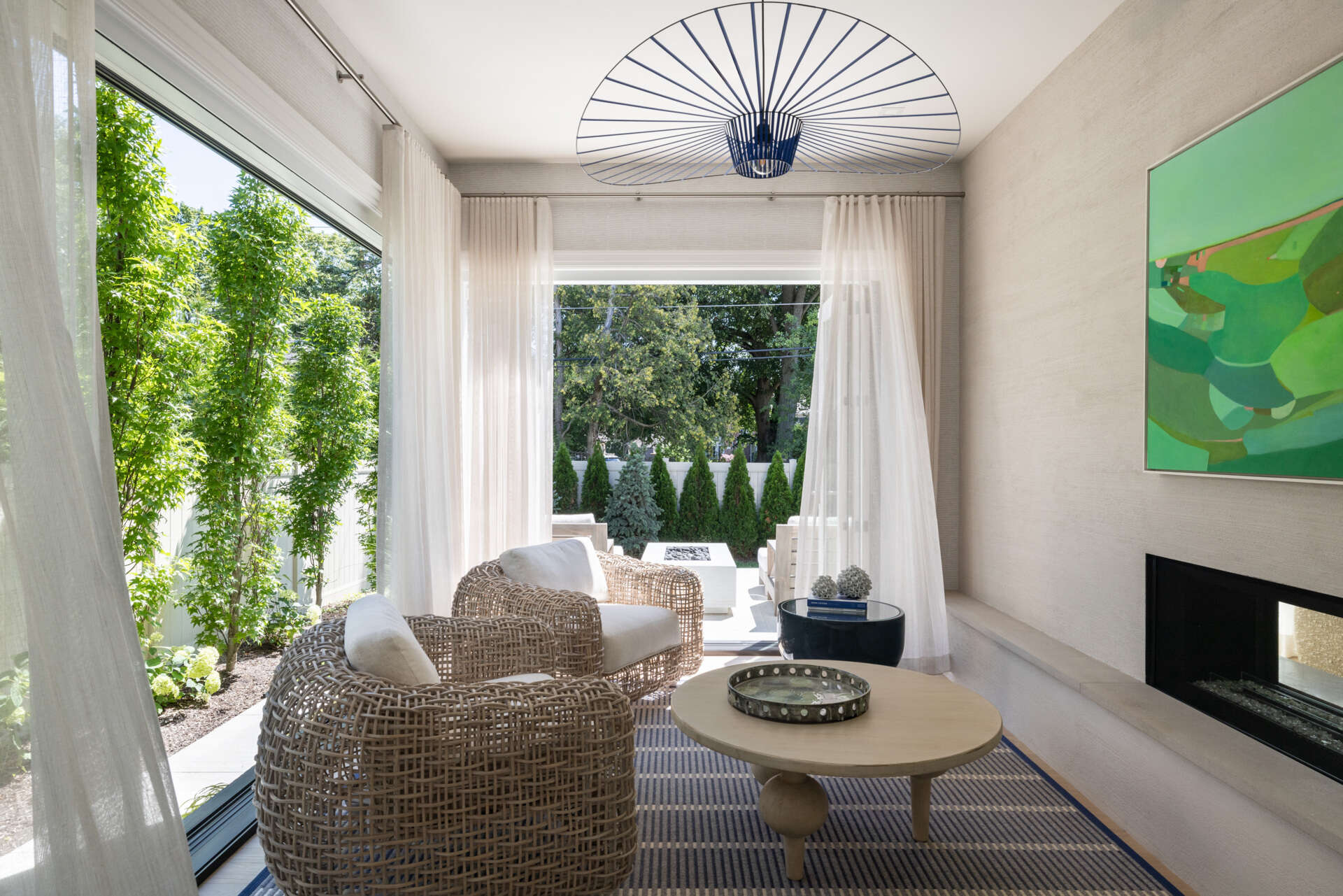 Slide the glass wide and the living space keeps going. The lanai picks up the home’s palette, so there is no harsh break between inside and out. You get firepit nights, breezy lunches, and that rare sense that the house is relaxing with you.