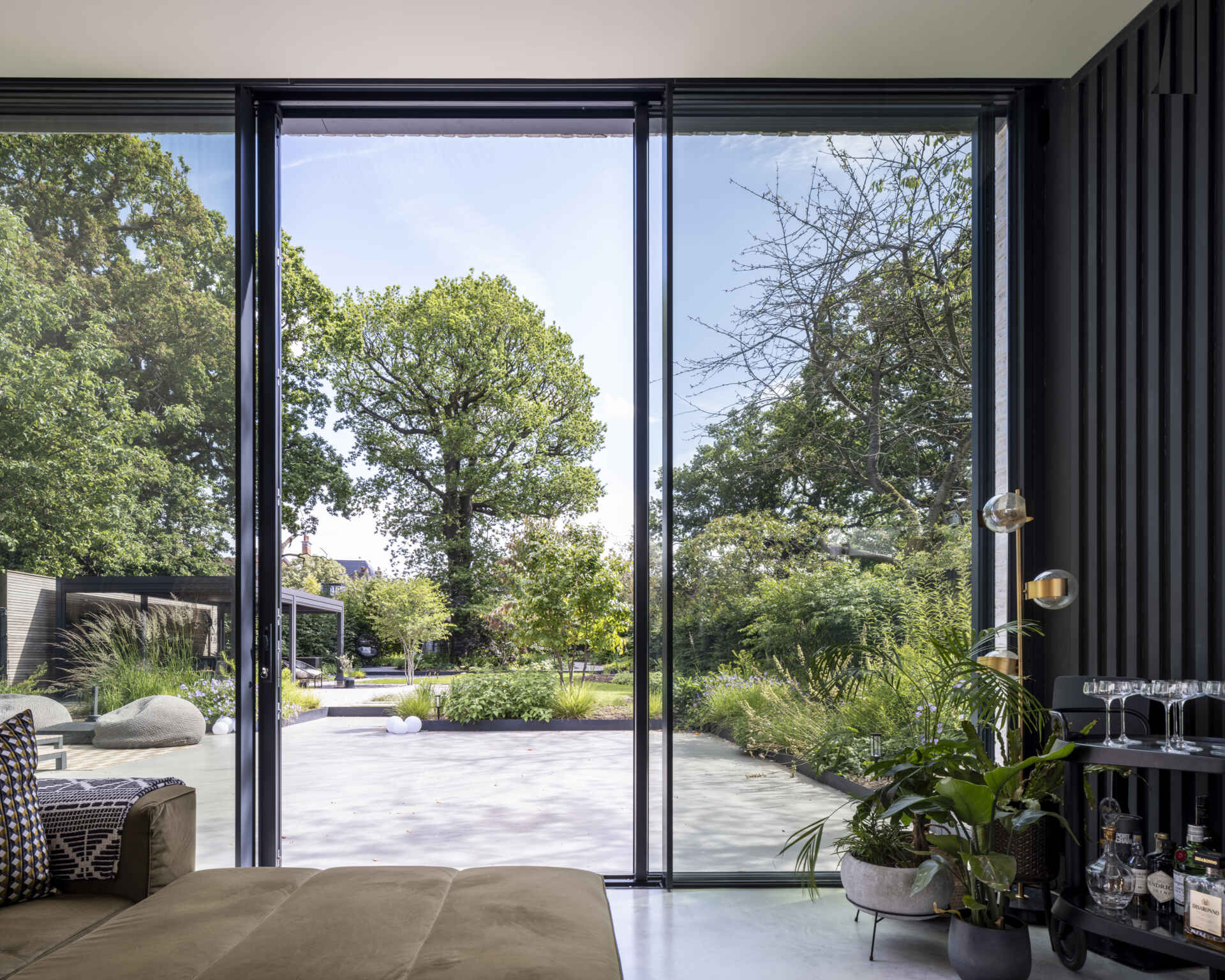 Sliding doors open the living room to the garden, creating an effortless indoor-outdoor connection.