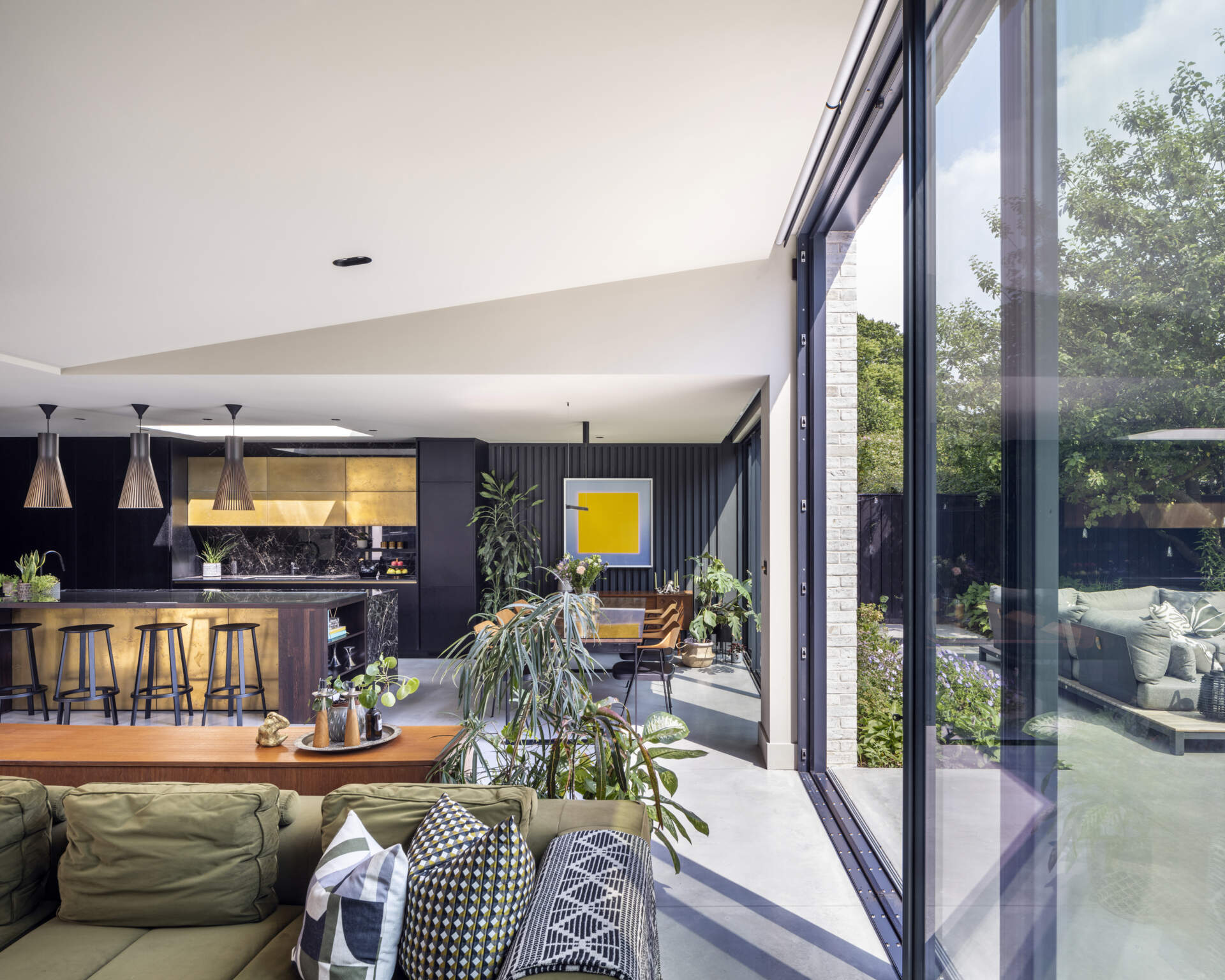 Sliding doors open the living room to the garden, creating an effortless indoor-outdoor connection.