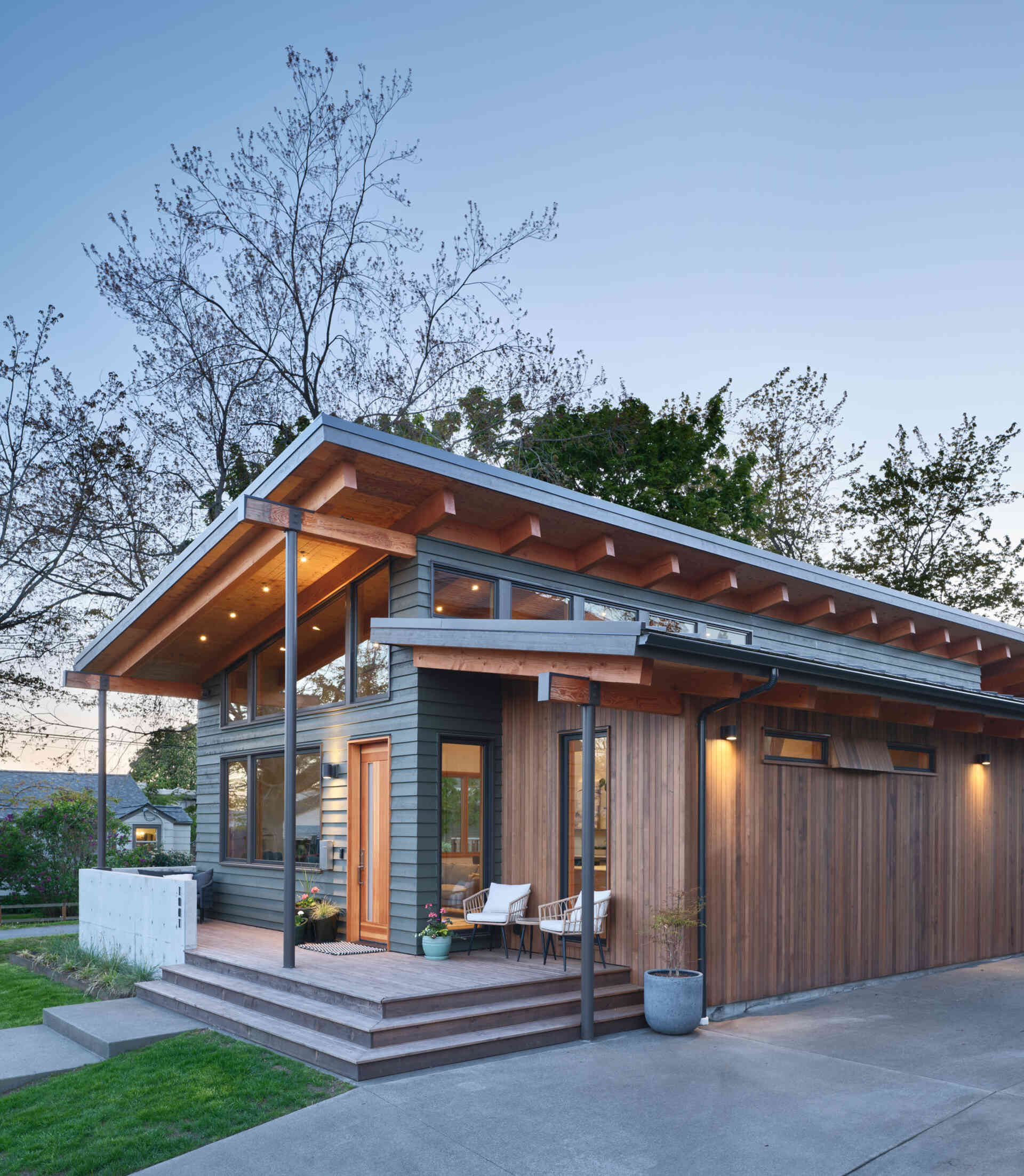 A modern ADU in the style of Pacific Northwest architecture, with a sloping roof and exposed wood beams.