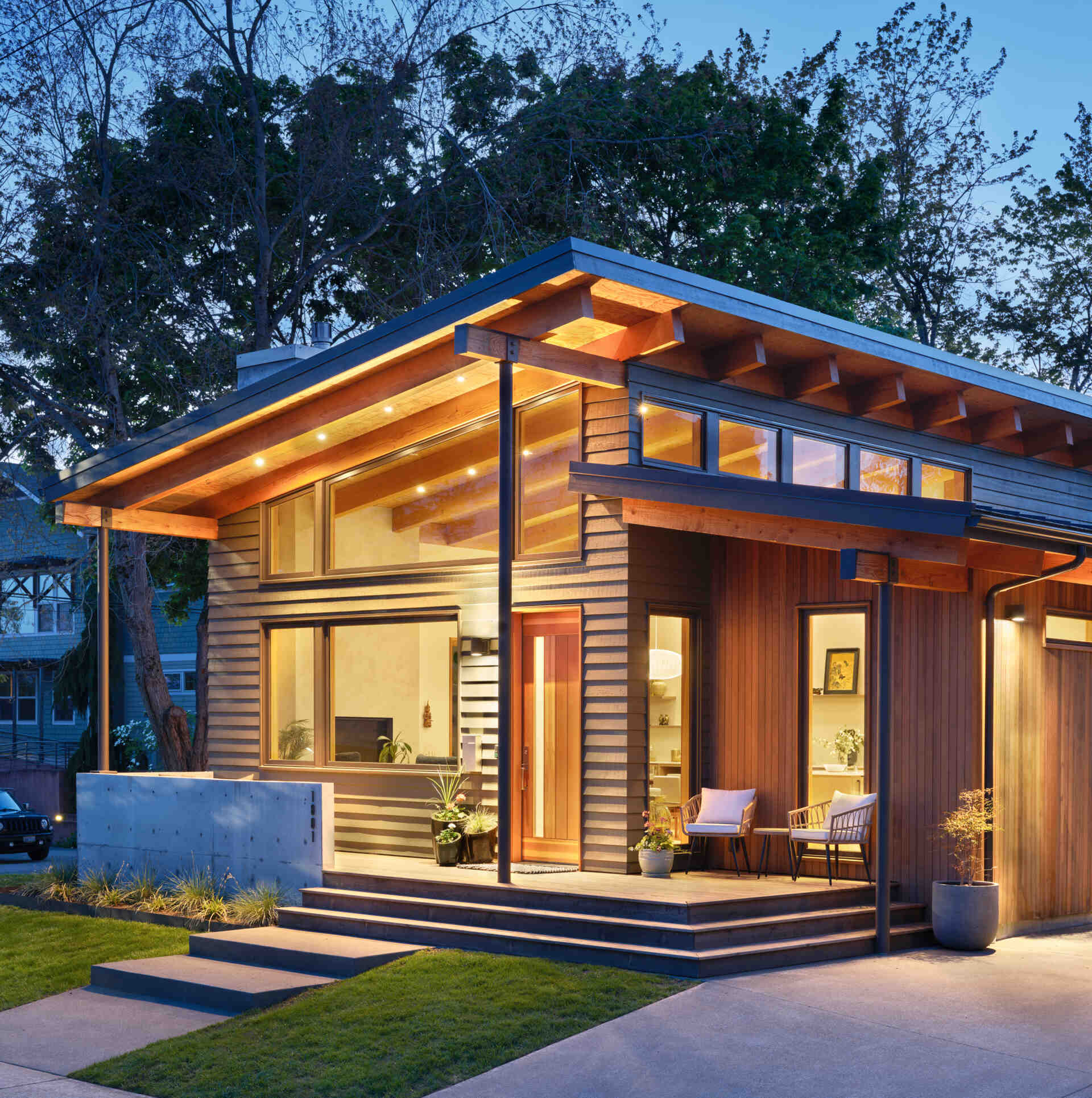A modern ADU in the style of Pacific Northwest architecture, with a sloping roof and exposed wood beams.