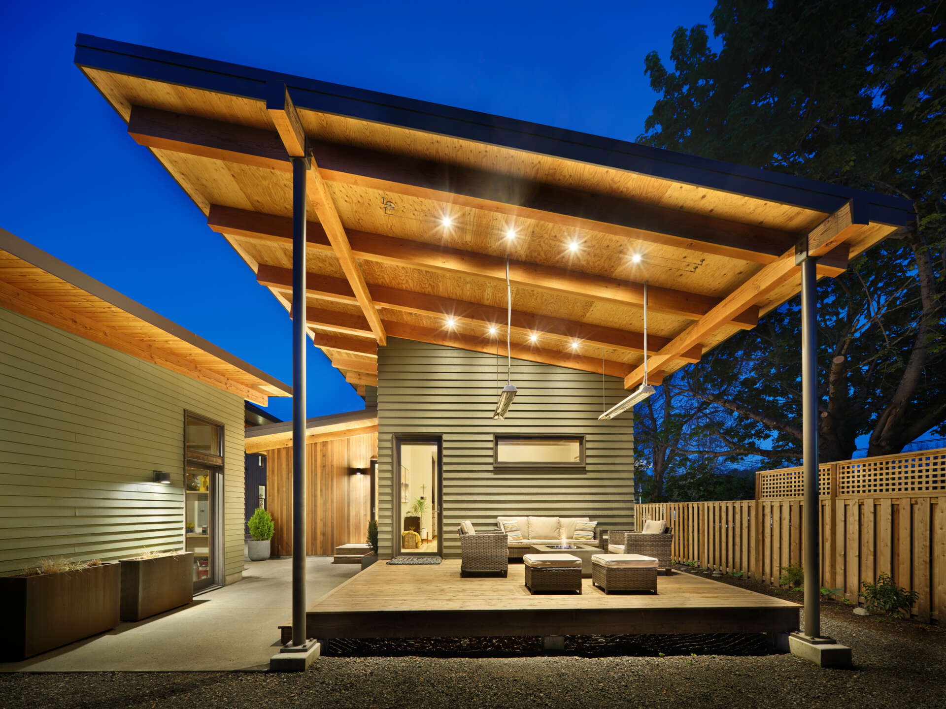 A modern ADU in the style of Pacific Northwest architecture, with a sloping roof and exposed wood beams.