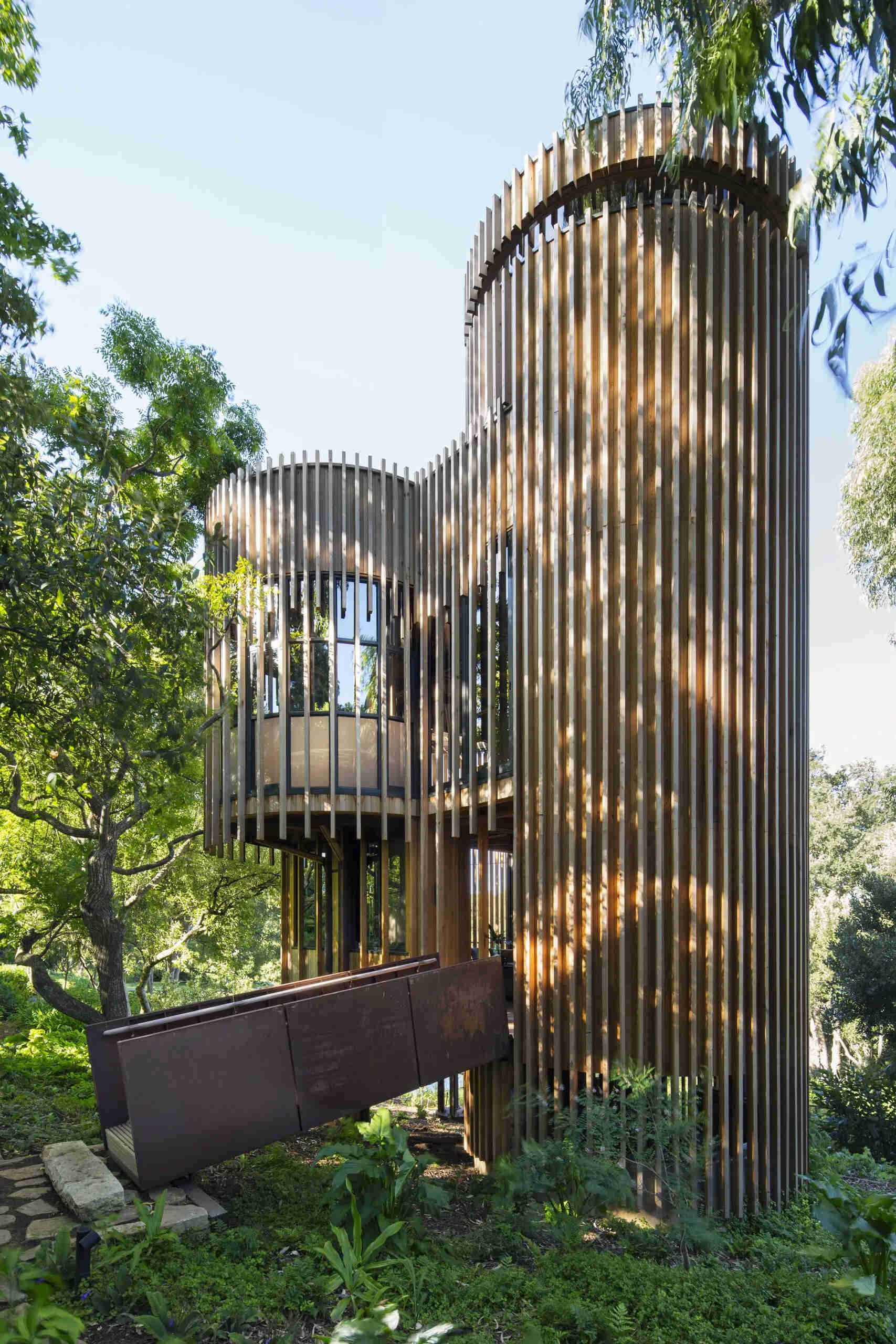 A suspended timber and steel ramp leads into the home, setting the tone for its blend of lightness and strength.