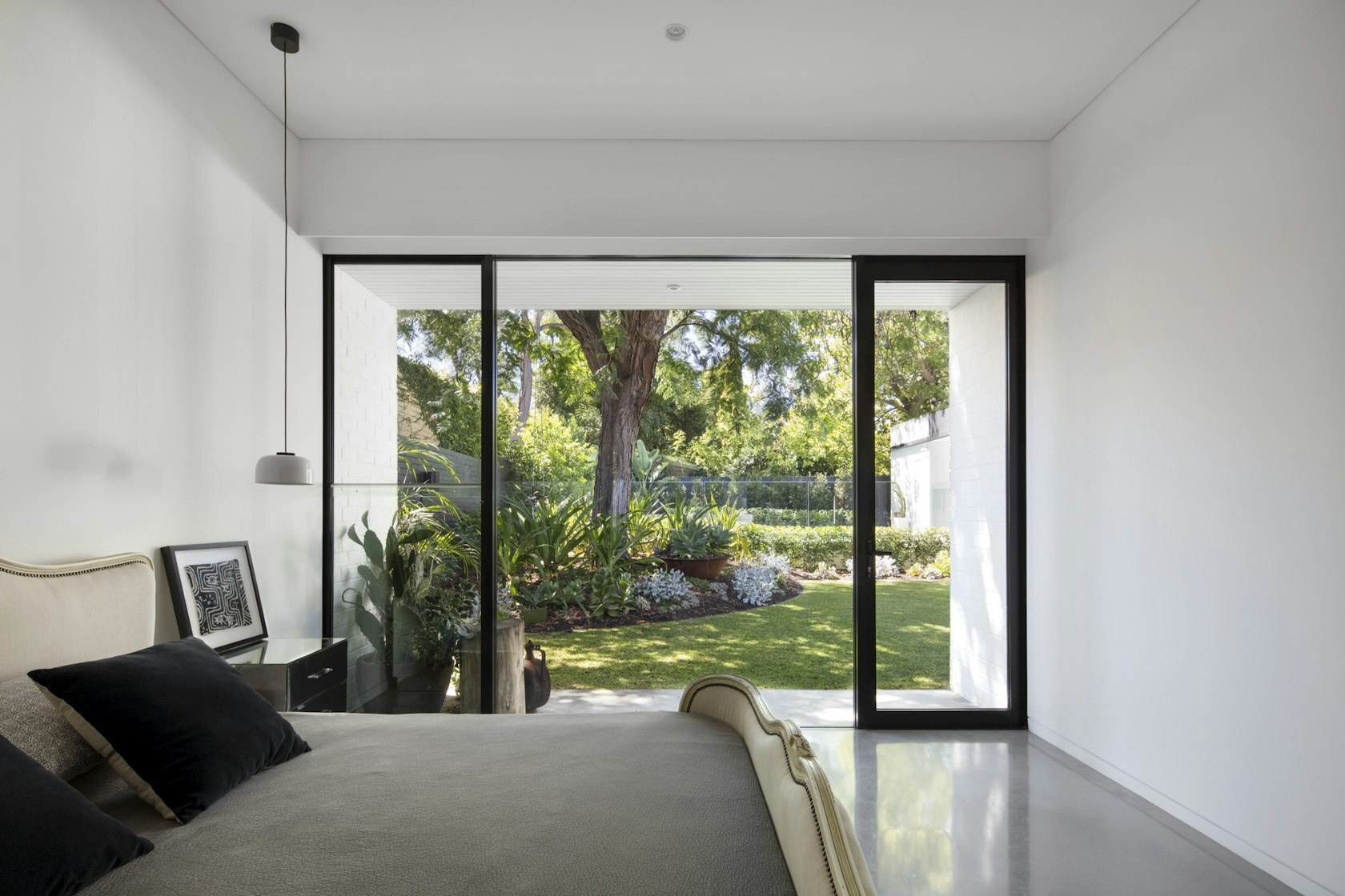Bedroom with direct garden access, designed for calm, light-filled mornings.