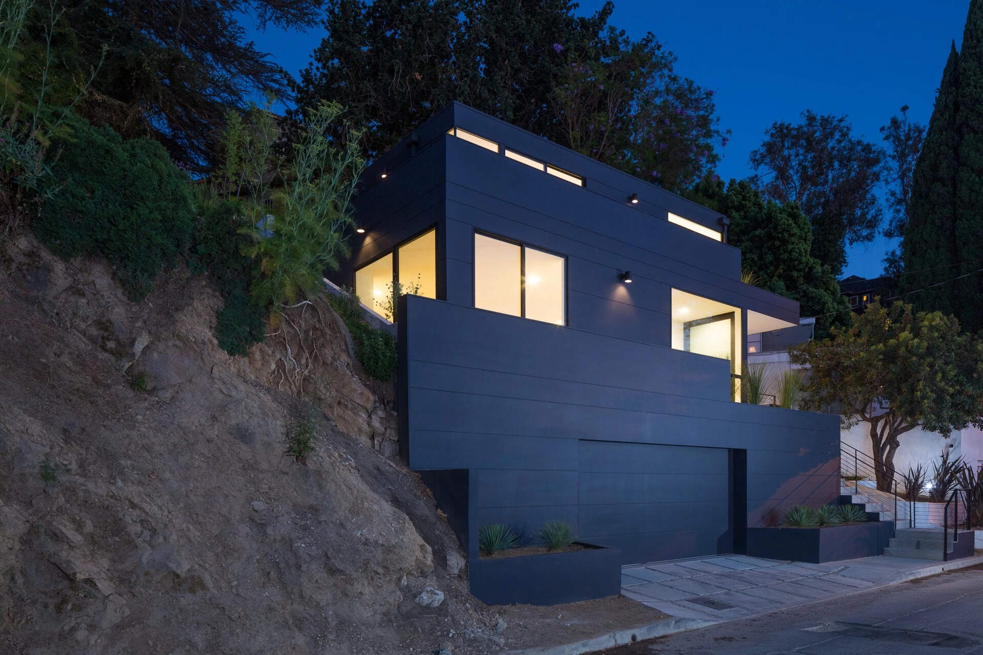 A striking black home in Silver Lake that transforms a steep hillside site into a seamless blend of light, space, and minimalist design.