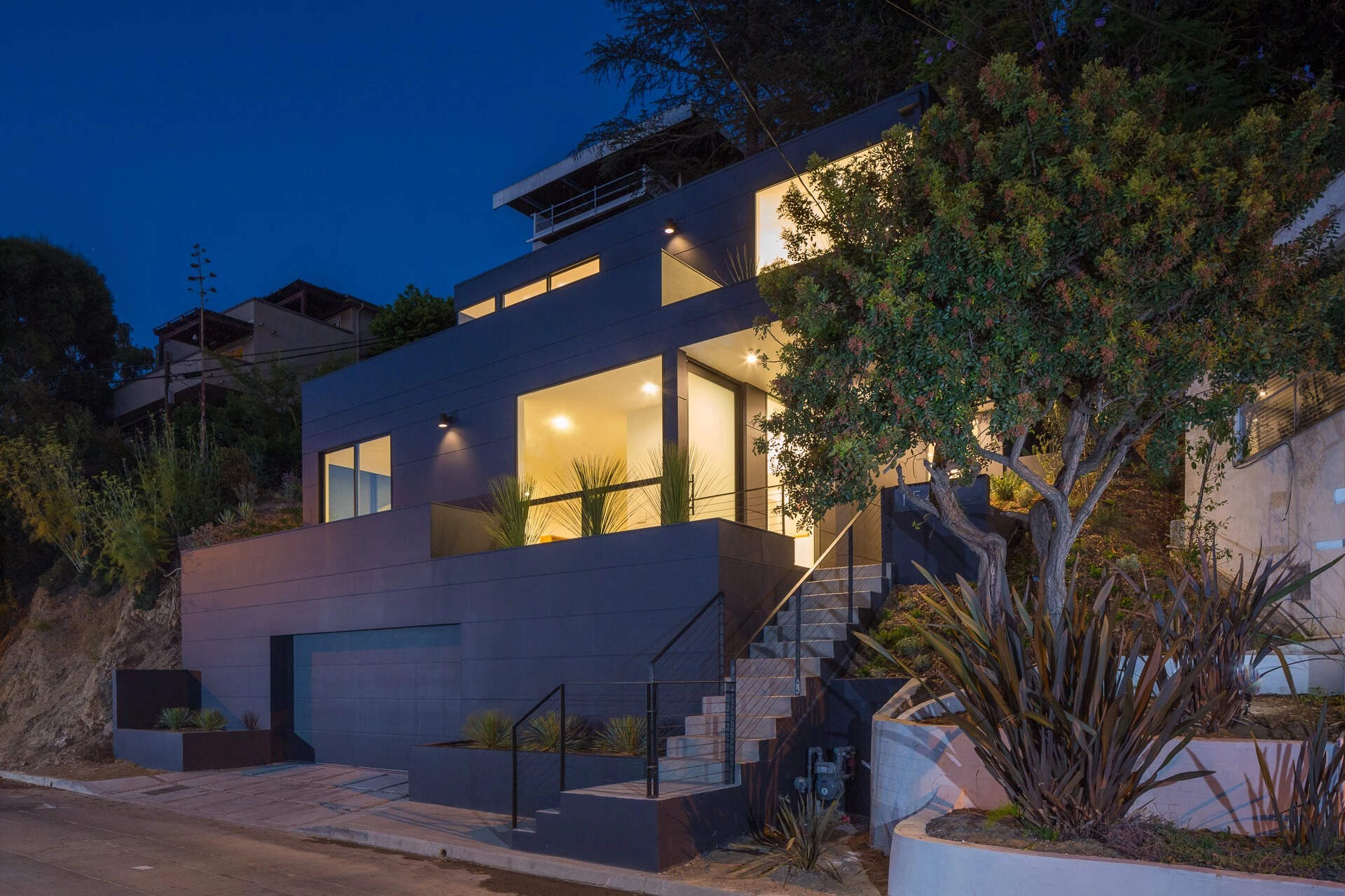 A striking black home in Silver Lake that transforms a steep hillside site into a seamless blend of light, space, and minimalist design.