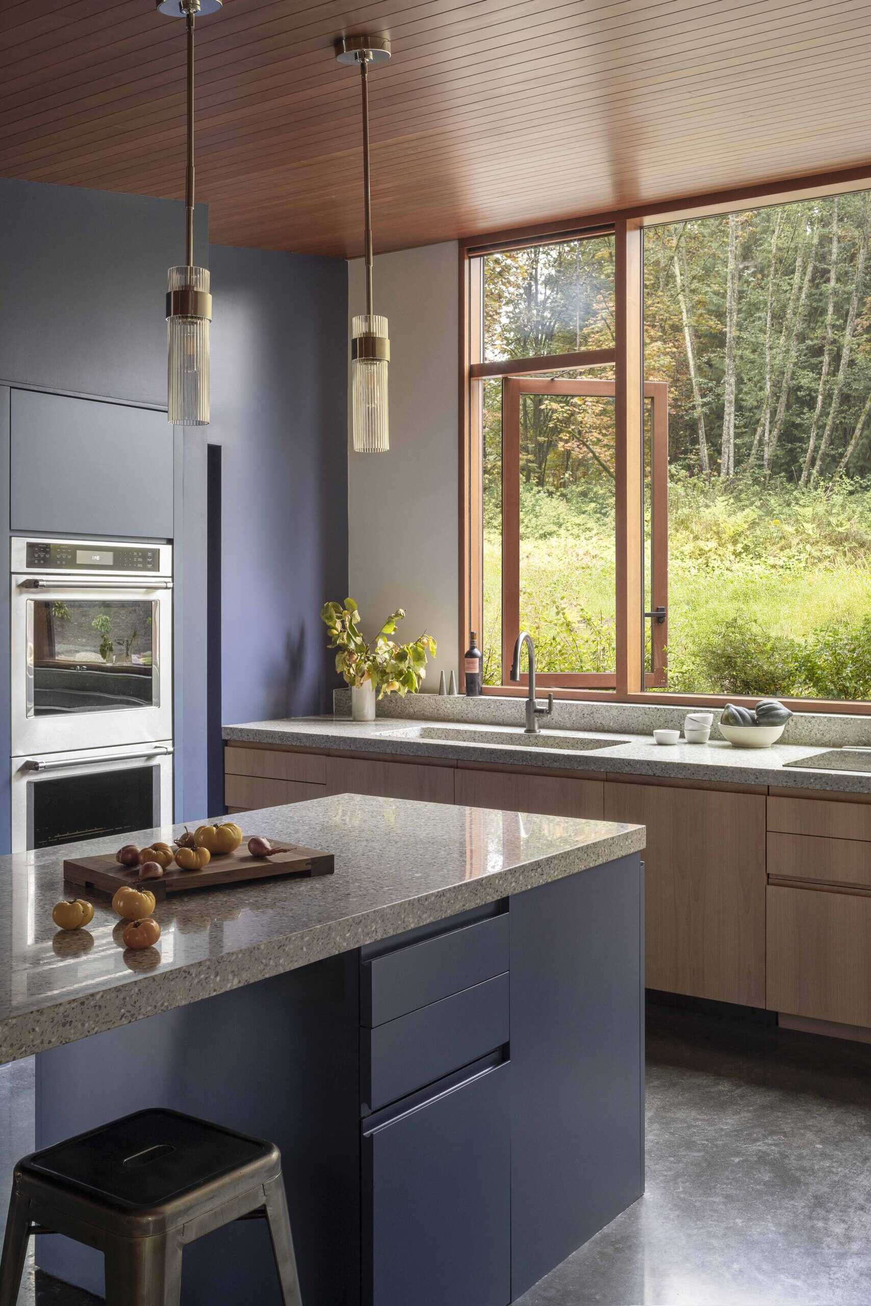 A modern kitchen with matte blue cabinets.