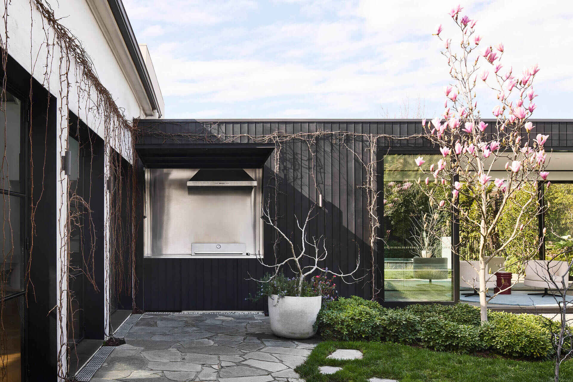 A patio and concealed BBQ blur the line between architecture and garden in this modern Australian home.