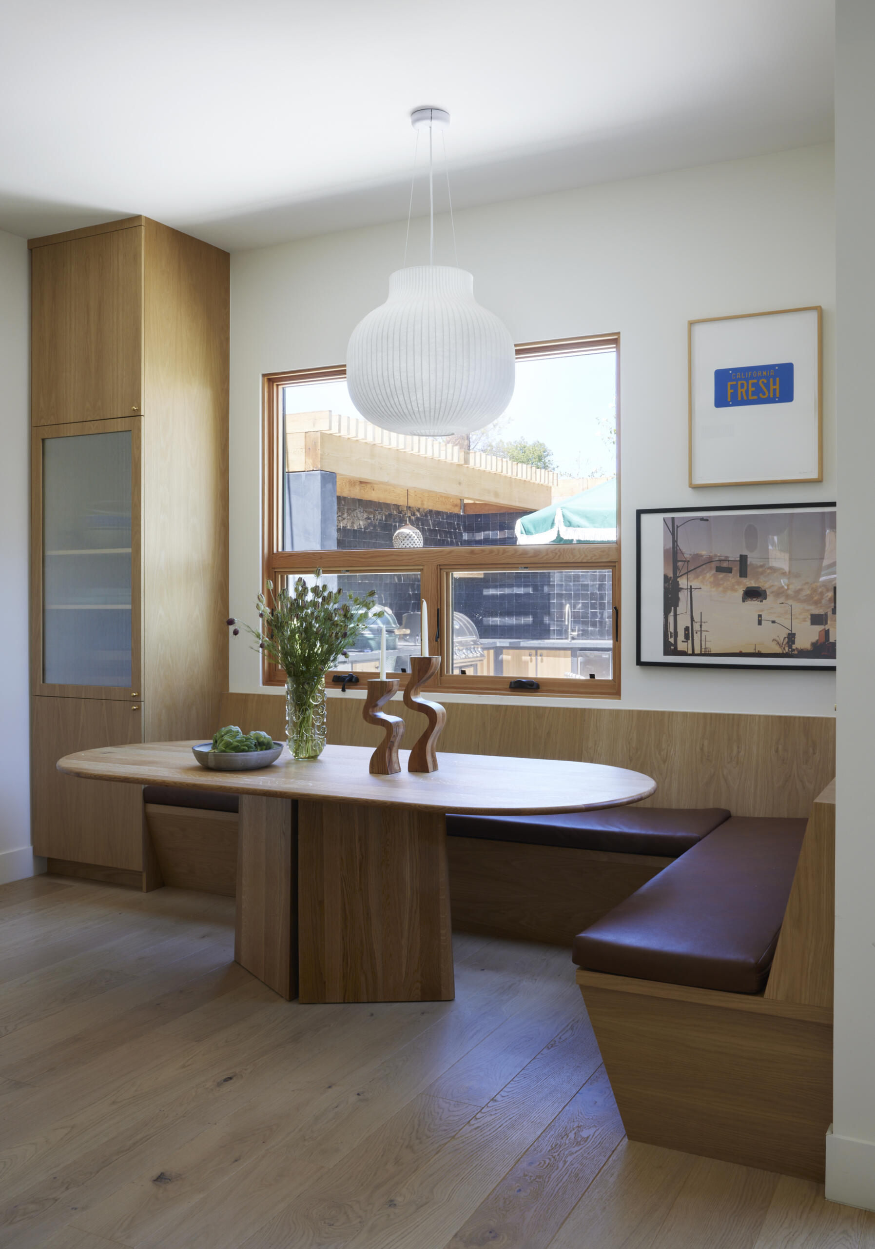 A cozy banquette transforms the dining nook into a perfect spot for family meals, designed to maximize space without sacrificing comfort.