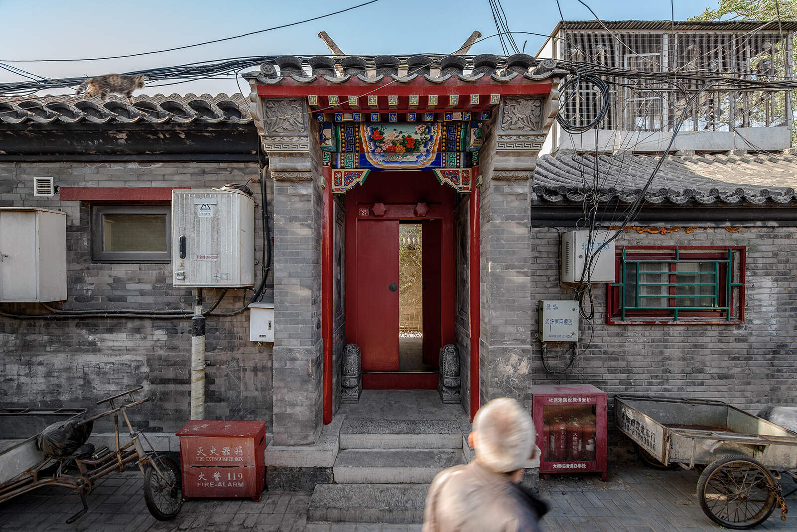 The Twisting Courtyard in Beijing invites visitors through a red door into a historic Siheyuan, now transformed into a modern, flexible public space.