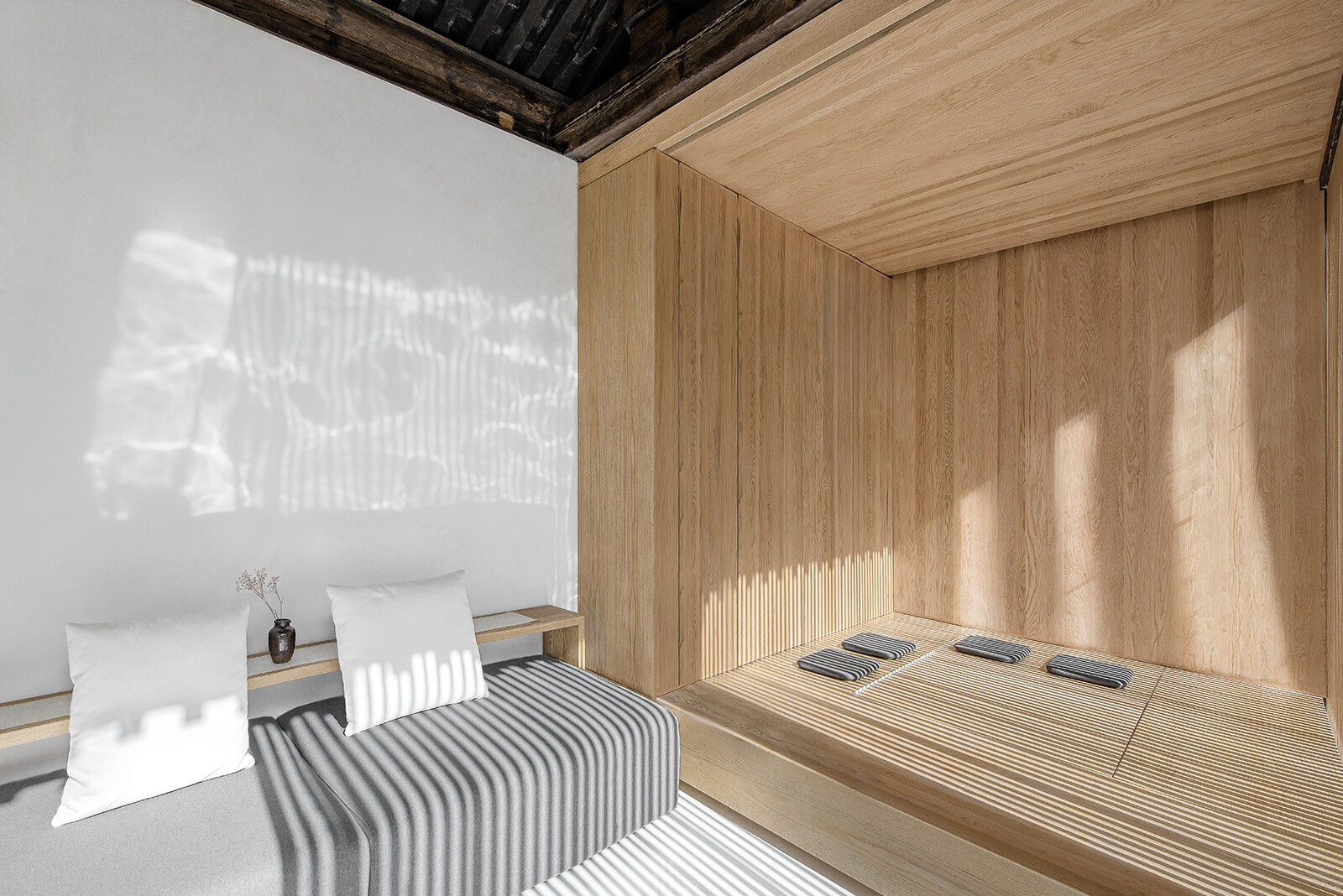 Furniture boxes allow rooms to switch from tea room to bedroom, offering flexibility without sacrificing style.