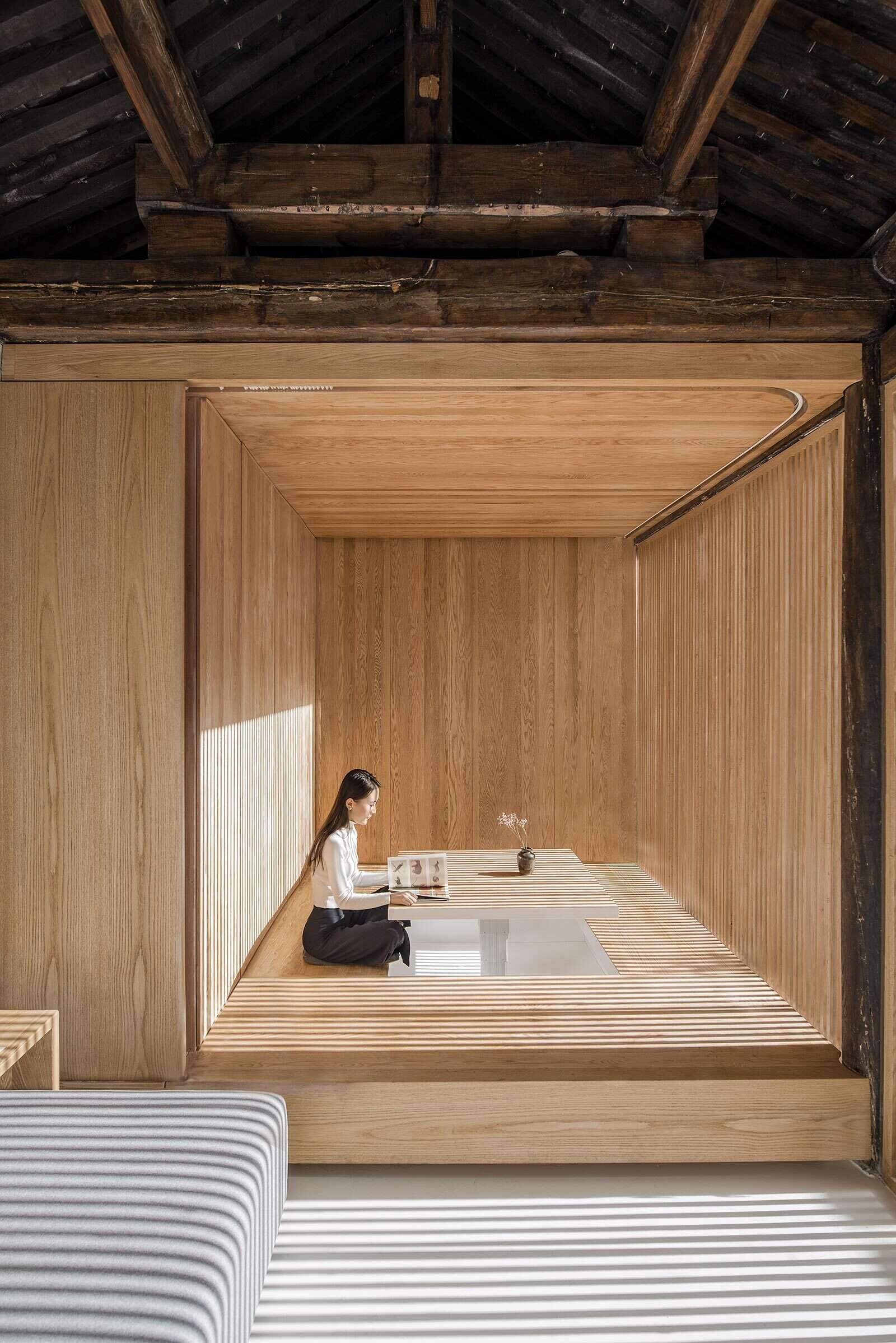 Furniture boxes allow rooms to switch from tea room to bedroom, offering flexibility without sacrificing style.
